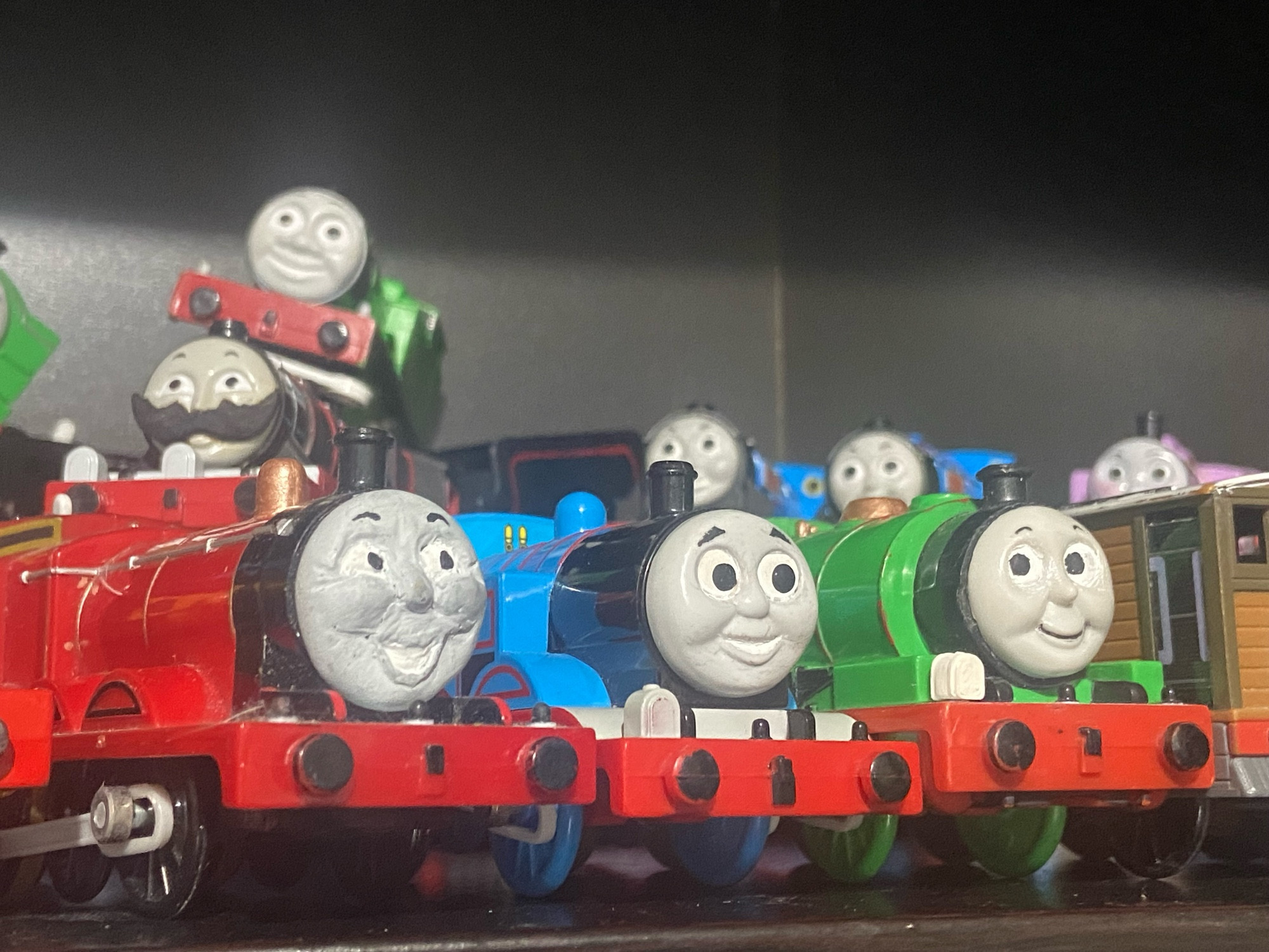 A photo of various Thomas and friends characters as TOMY Toy Trains.

Front row: Duncan’s bufferbeam, James the Red Engine, Thomas the Tank Engine, Percy the Small Engine, and Toby the Tram Engine

Back row: Fartrum, Oliver the Great Western Engine, Donald the Scottish Twin, Douglas the Scottish Twin, Rosie