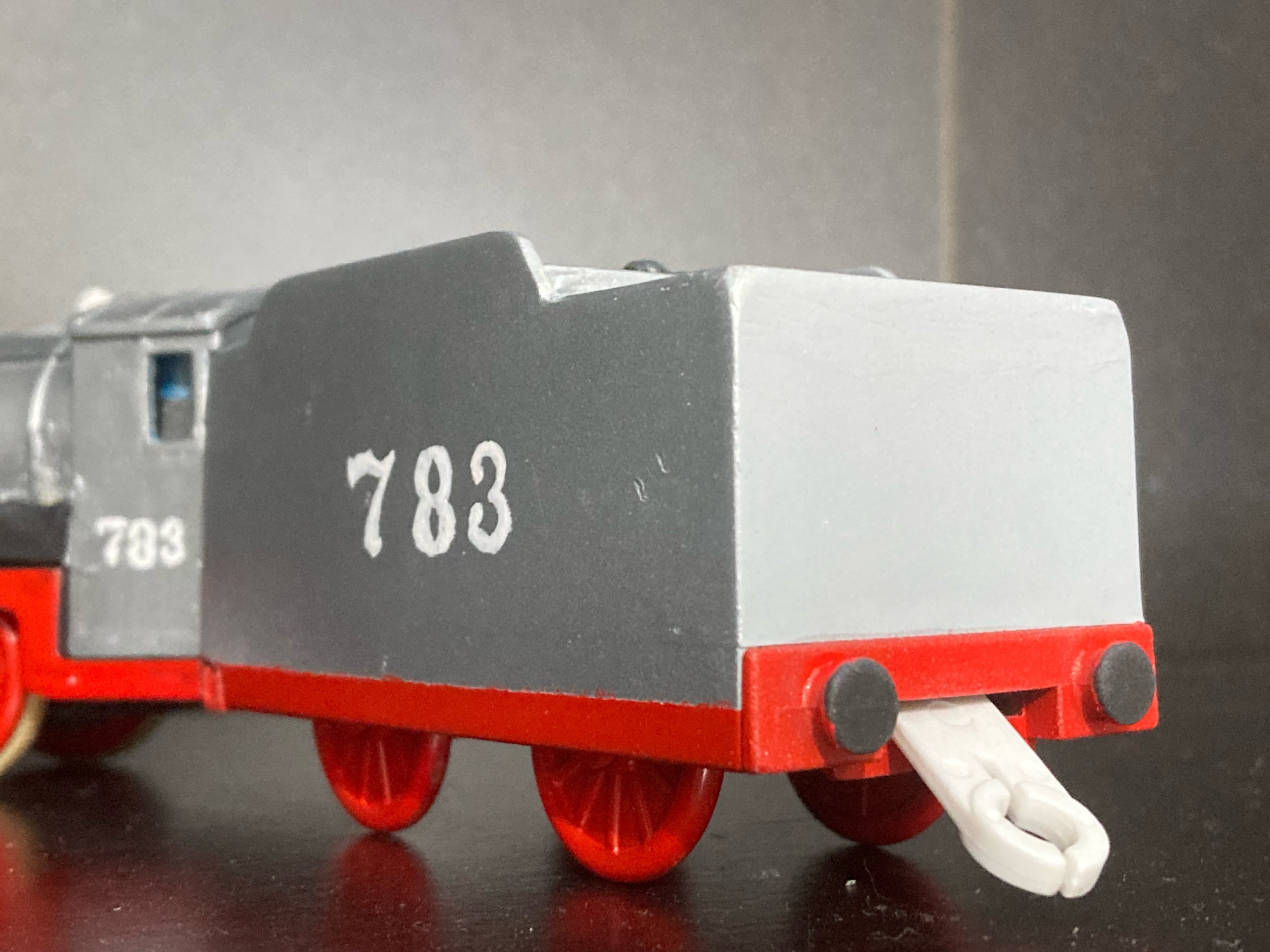 Merlin’s Tender, made from Henry’s Tender, it is Silver with red wheels, a red bufferbeam, and a white number 783.