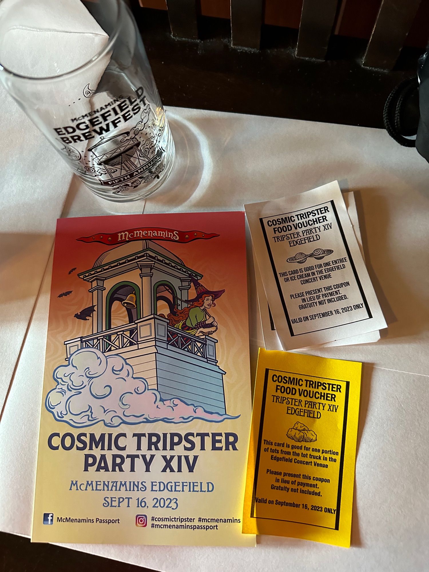 Pint glass, food vouchers, and party program