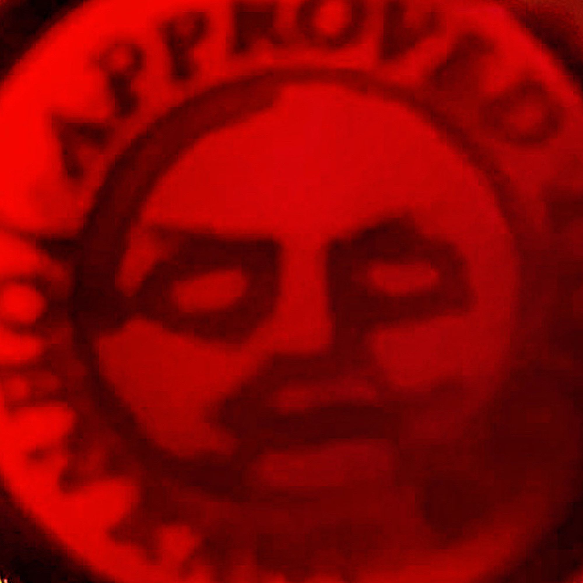 a red wax seal of the John Kane Society logo with the sun shining through it