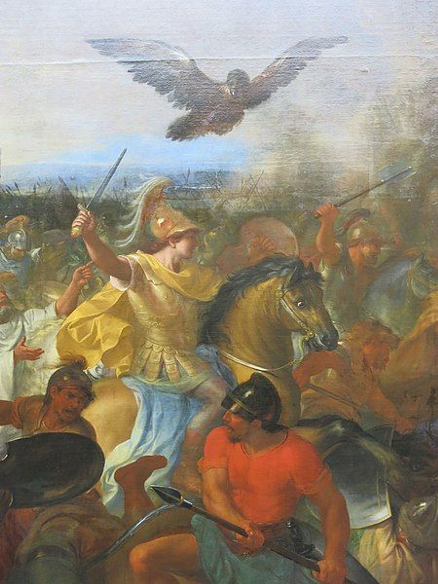 Détail du tableau de Charles Le Brun représentant la Bataille de Gaugamèles, avec au premier plan Alexandre le Grand portant un casque dorée, assis sur son cheval et brandissant une épée. Un aigle vole au dessus de lui. Devant lui, un homme avec un casque noir brandit une pique.