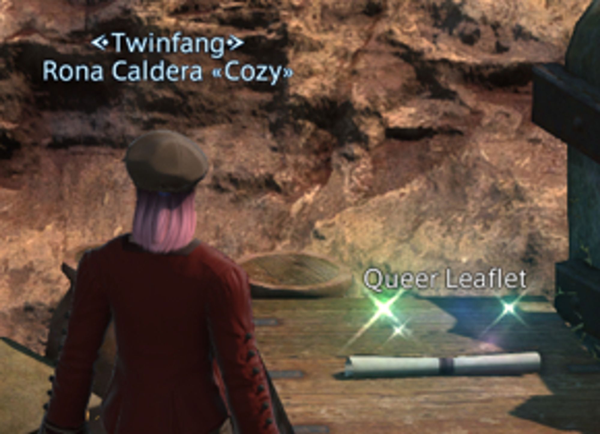 Screenshot from Final Fantasy XIV of a character with pink hair standing next to a rolled-up document. UI elements identify the character as "Rona Caldera" and the document as "Queer Leaflet".