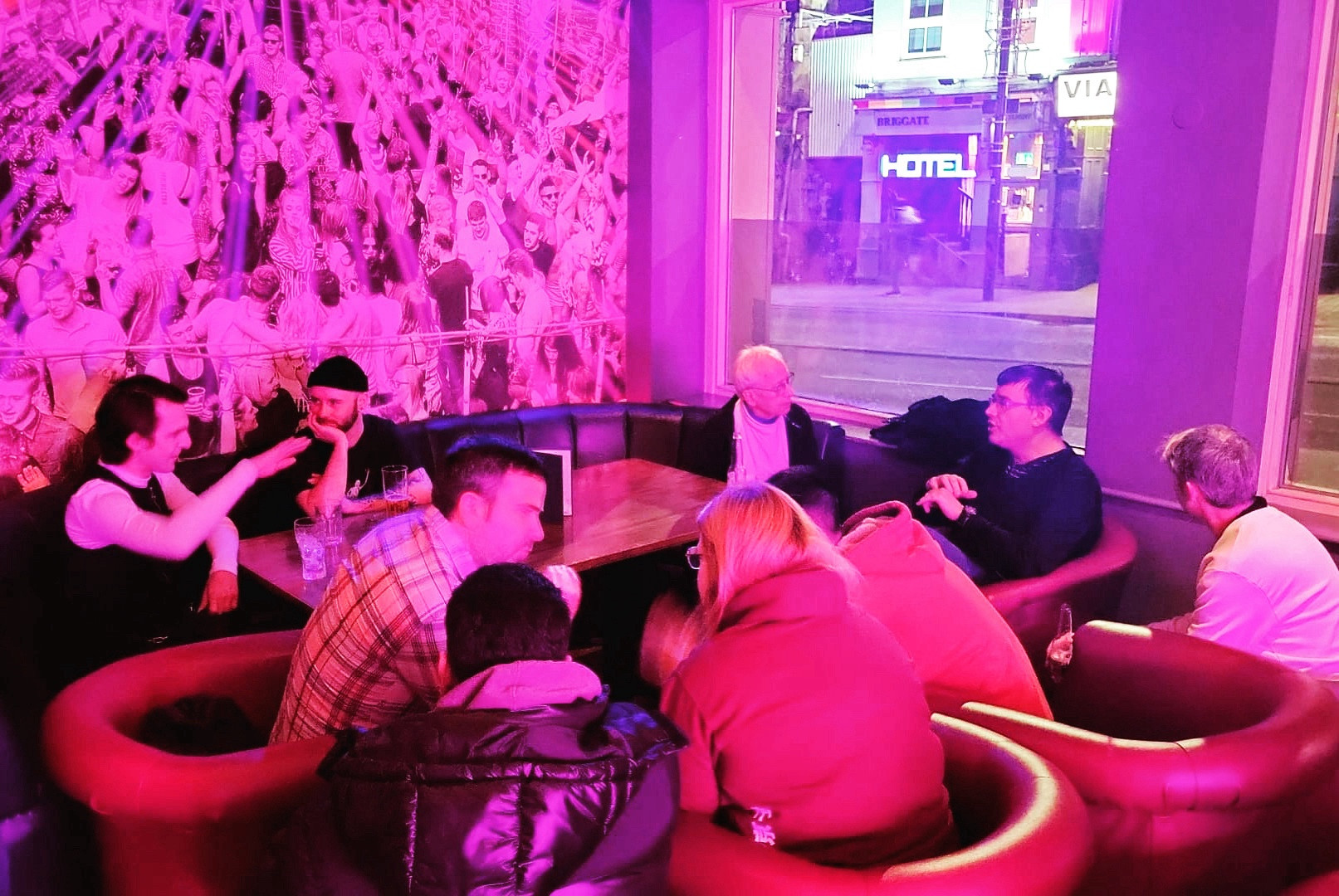 Photo showing group of people sat around large table