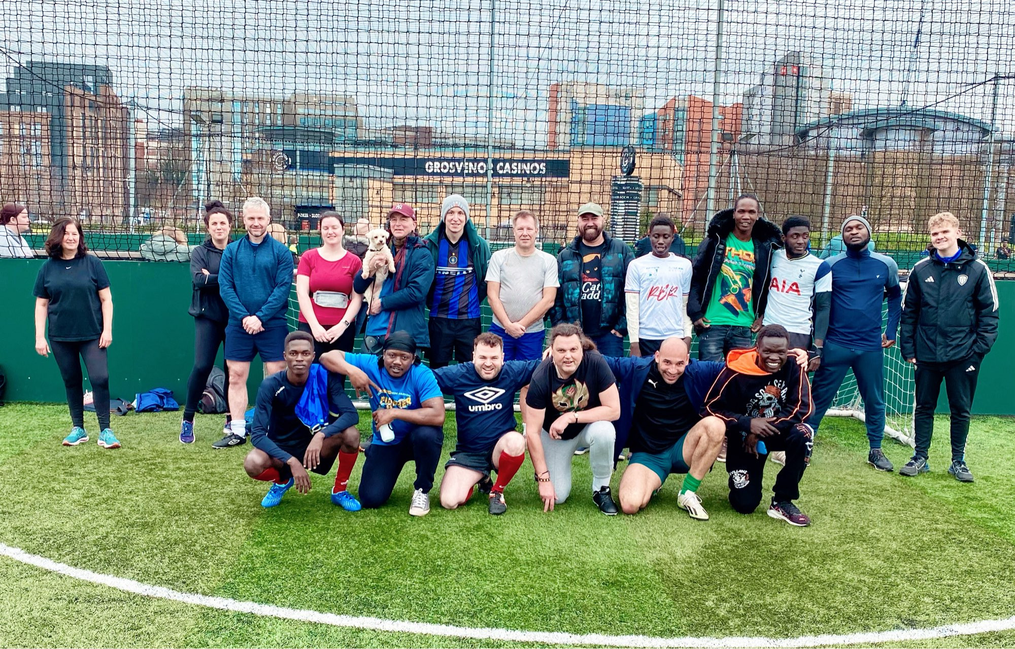 20 players grouped on pitch for photo