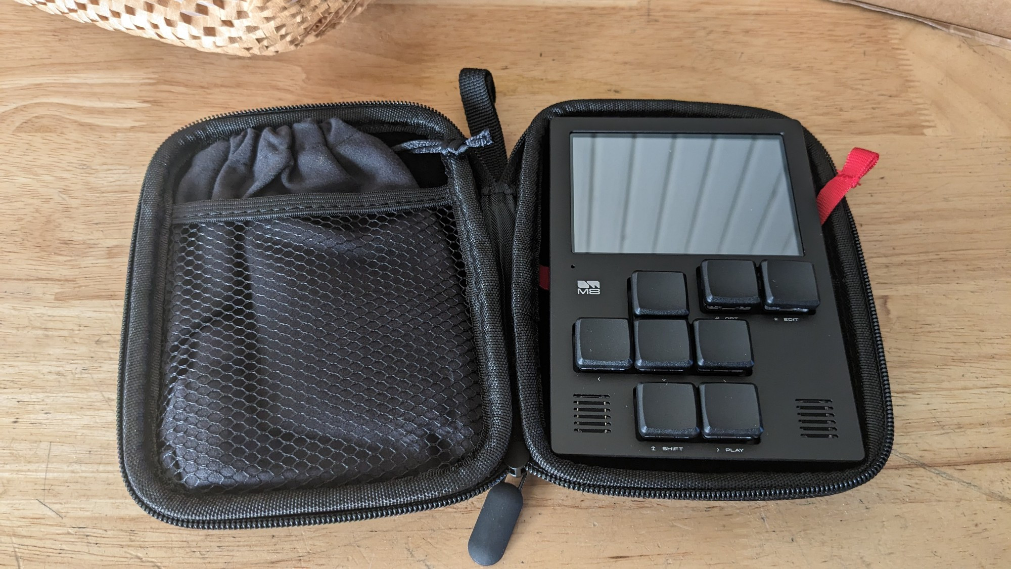 Inside the bag there's a small and solid piece of electronics with a screen on the top half and eight large buttons on the bottom half