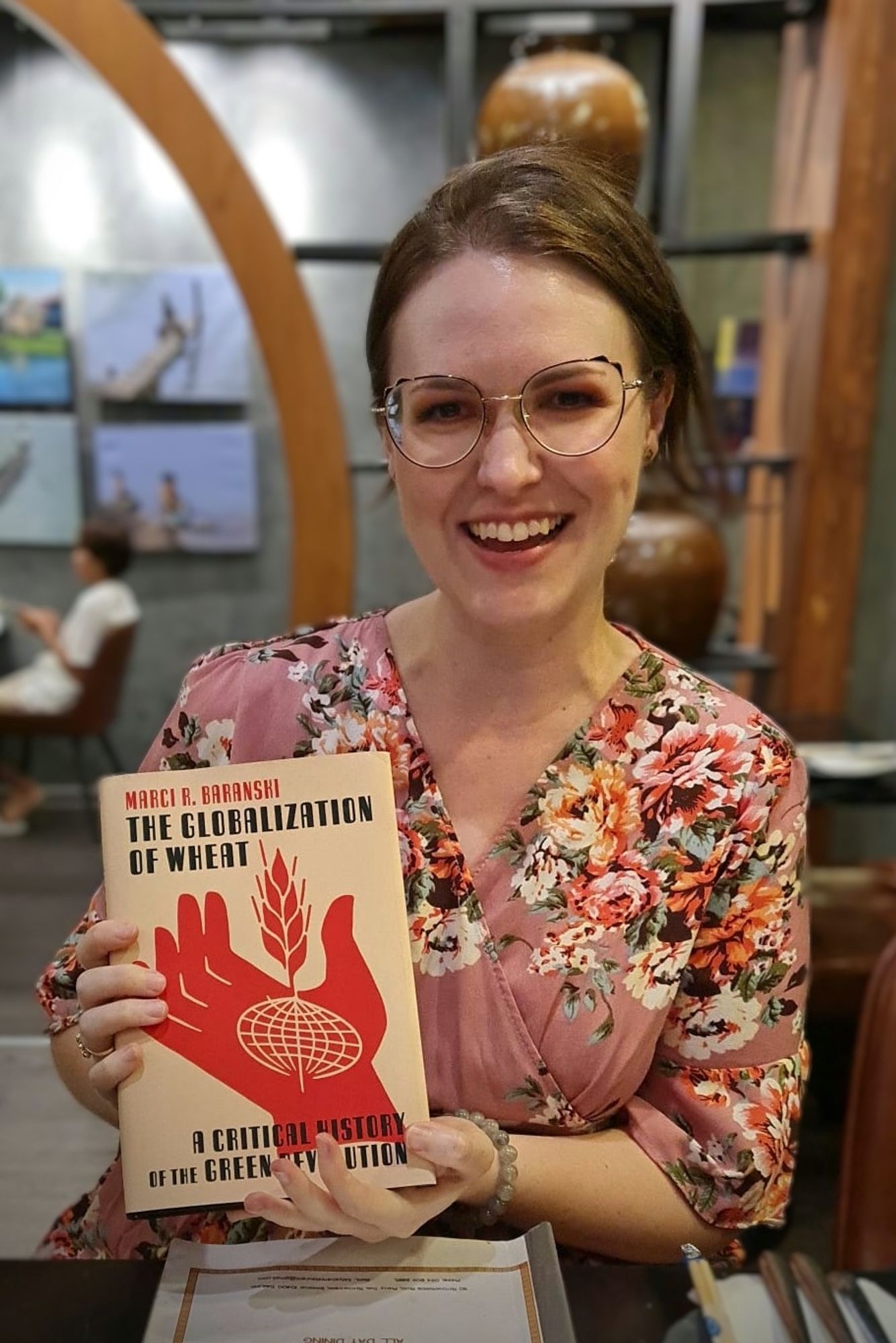 A photo of the poster holding the book she wrote 