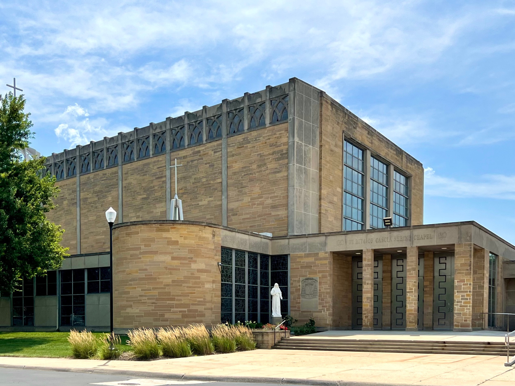 A view of the rectangular church building and tripartite entrance in the same frame.