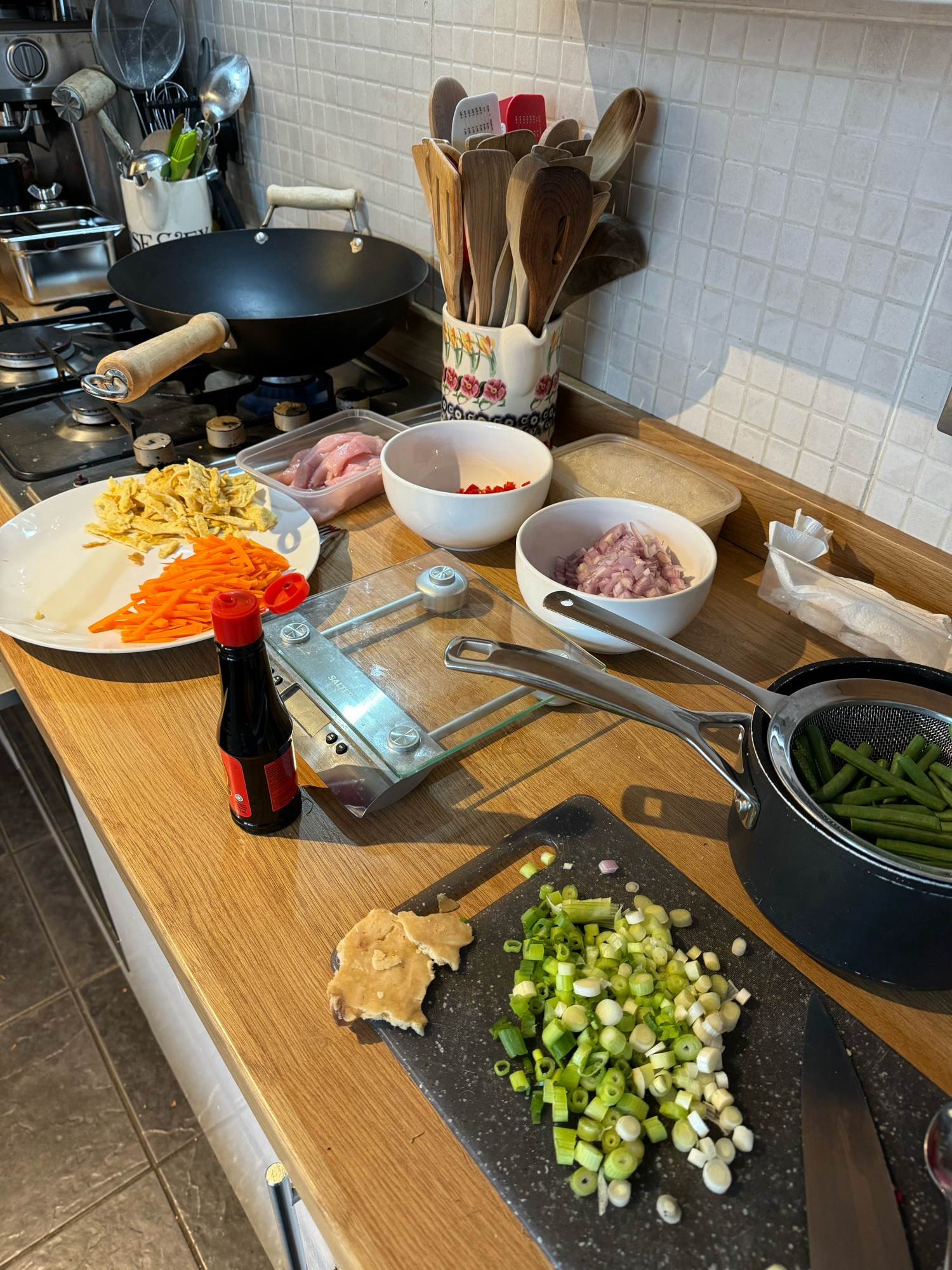 The ingredients for Nasi Goreng ready to cook, chopped shallot, spring onion, carrot, chili and others.