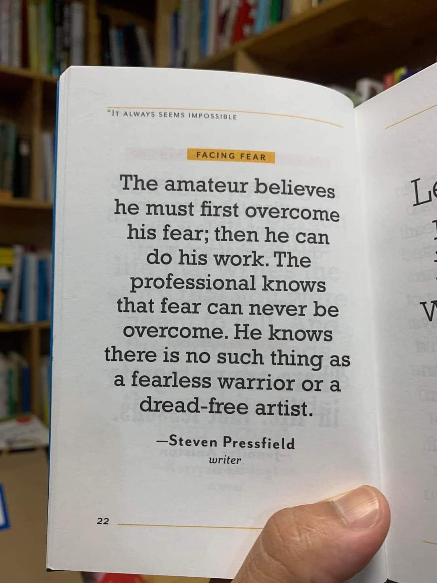 A page of a book that says "The amateur believes he must first overcome his fear; then he can do his work. The professional knows that fear can never be overcome. He knows there is no such thing as a fearless warrior or a dread-free artist. - Steven Pressfield" A big thumb holds the page open. The thumb looks thoughtful