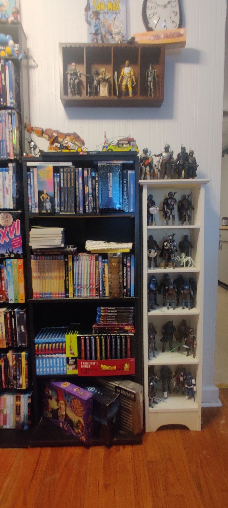 A secondary rack of movies, next to a shelf of Star wars figures