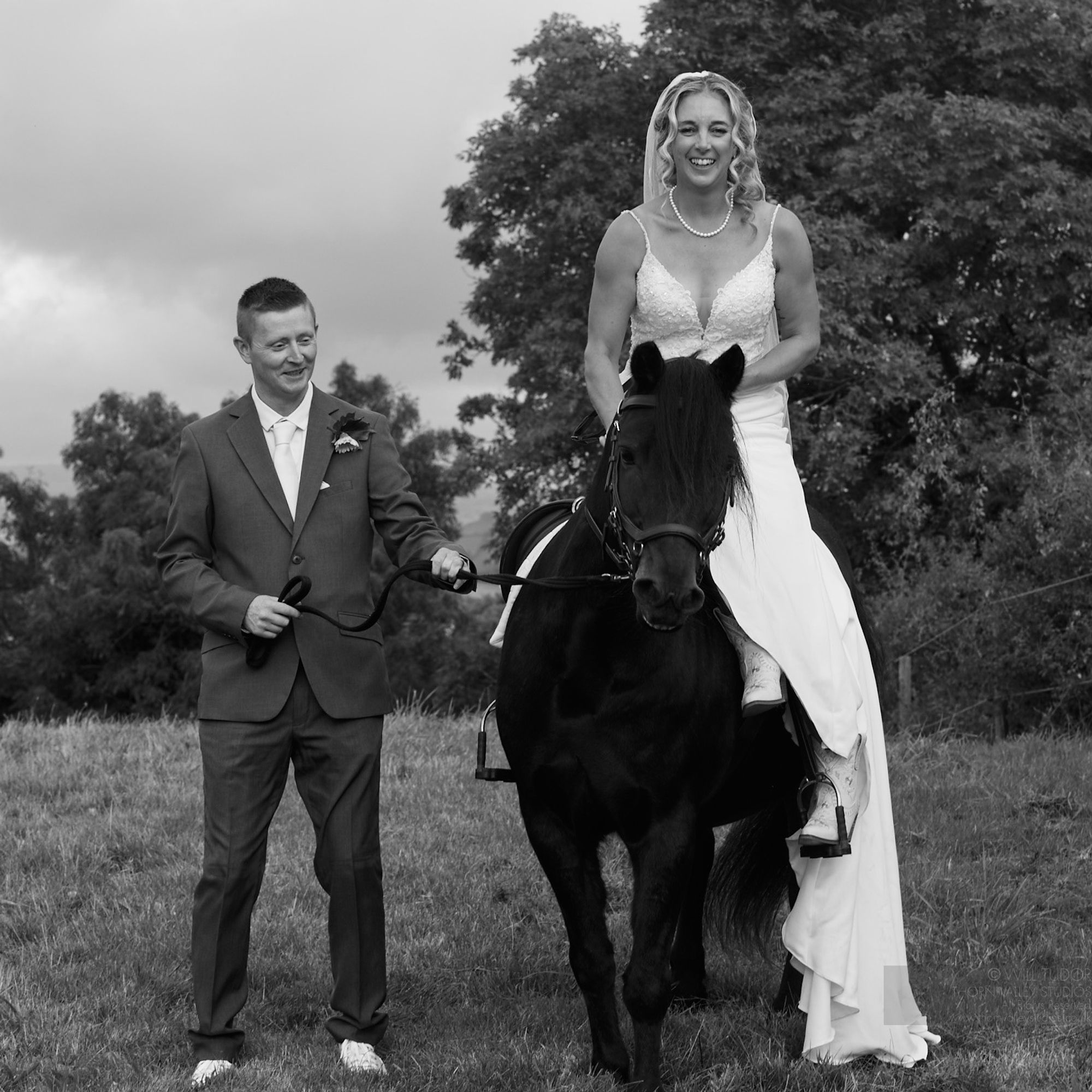 Bride & Groom on horse on their wedding day