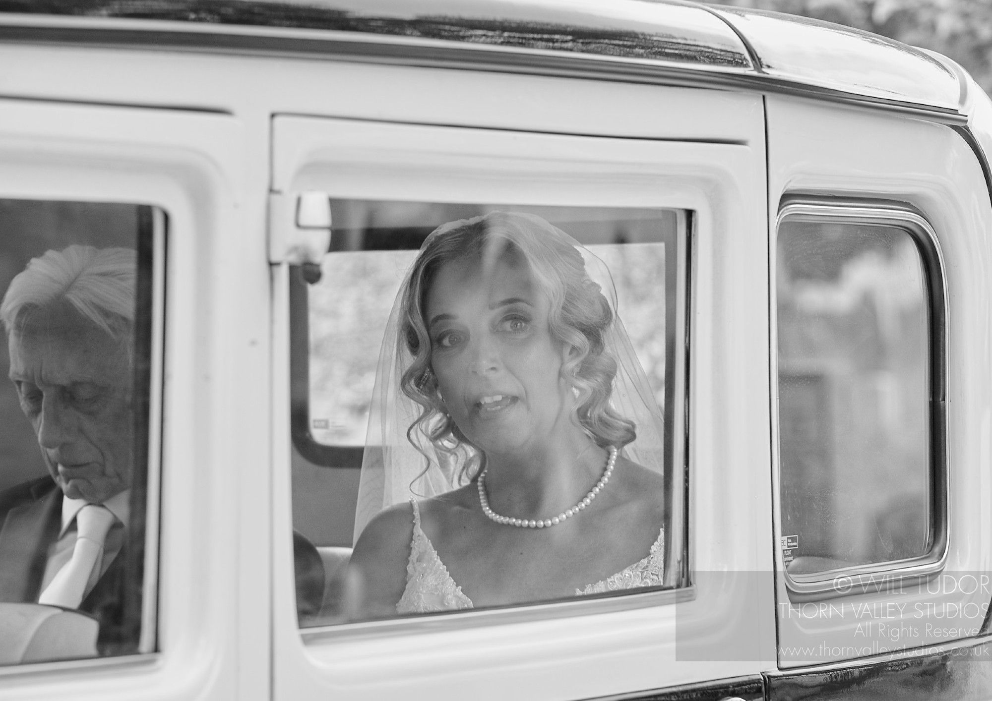 Bride arriving in antique car