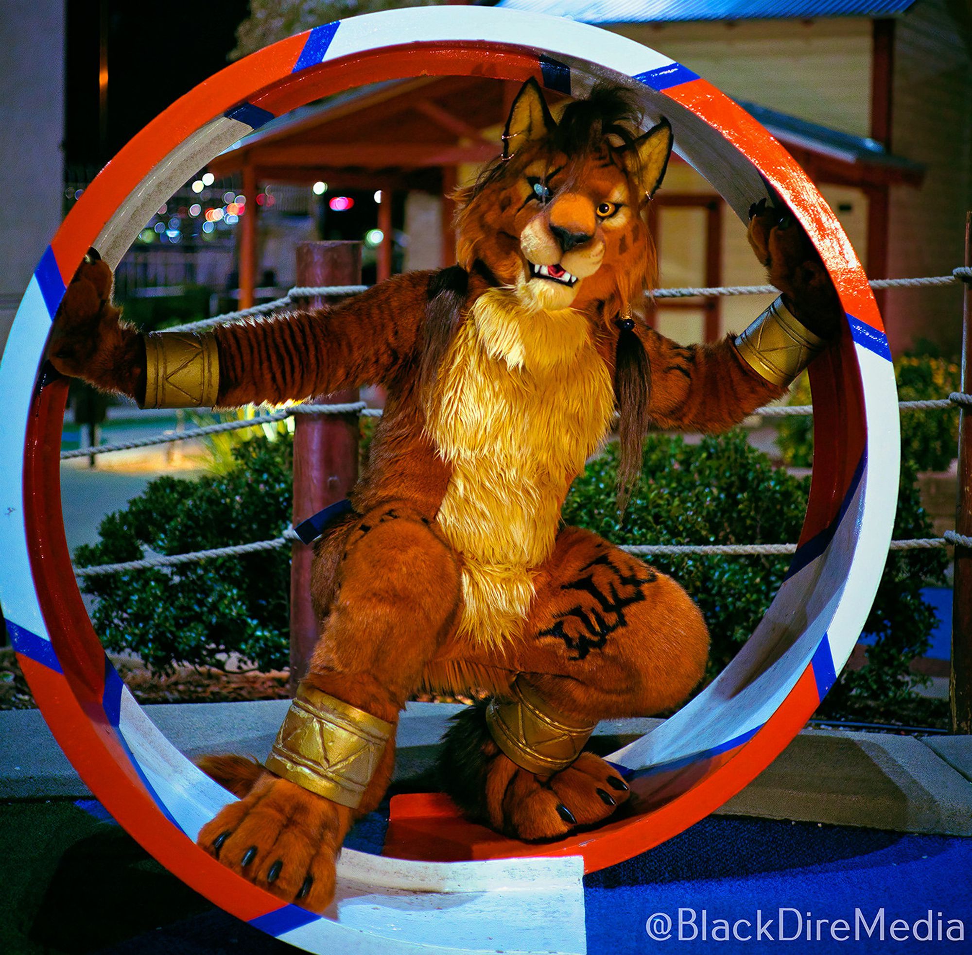 A Red XIII cosplayer crouches inside of a mini-golf course loop and looks at the camera.