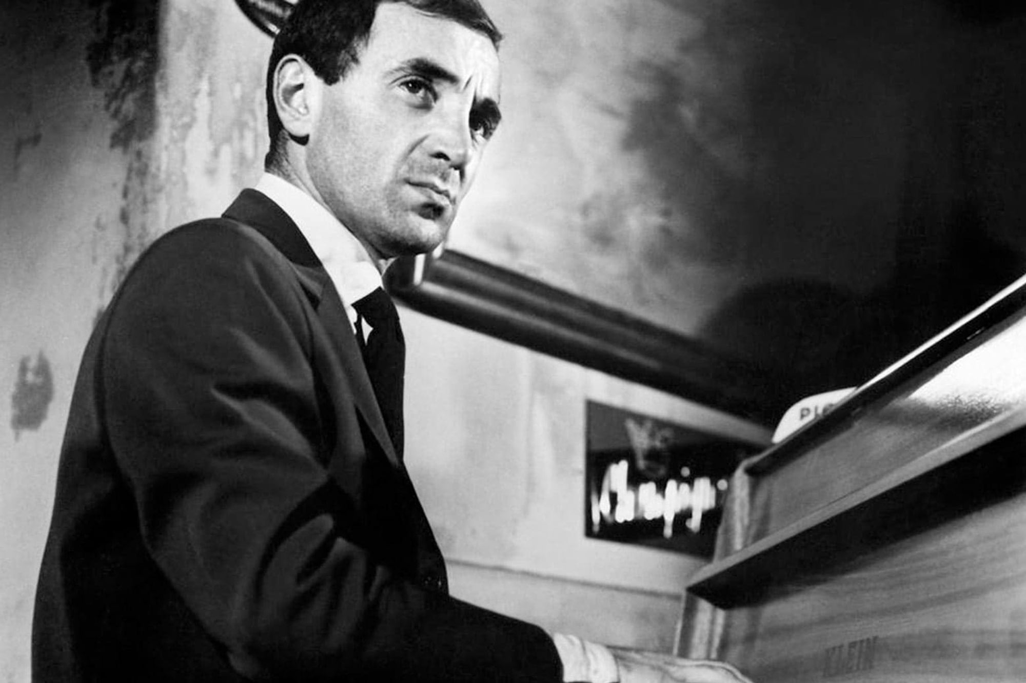 Charles Aznavour as Charlie Koller/Edouard Saroyan in Shoot the Piano Player (1960) he is seated at a piano