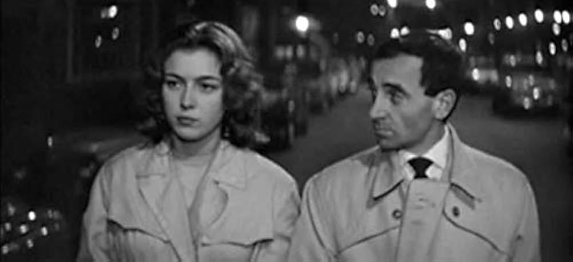 Charles Aznavour and Marie Dubois in Shoot the Piano Player. They're walking down the street, Dubois looks ahead while Aznavour looks at her