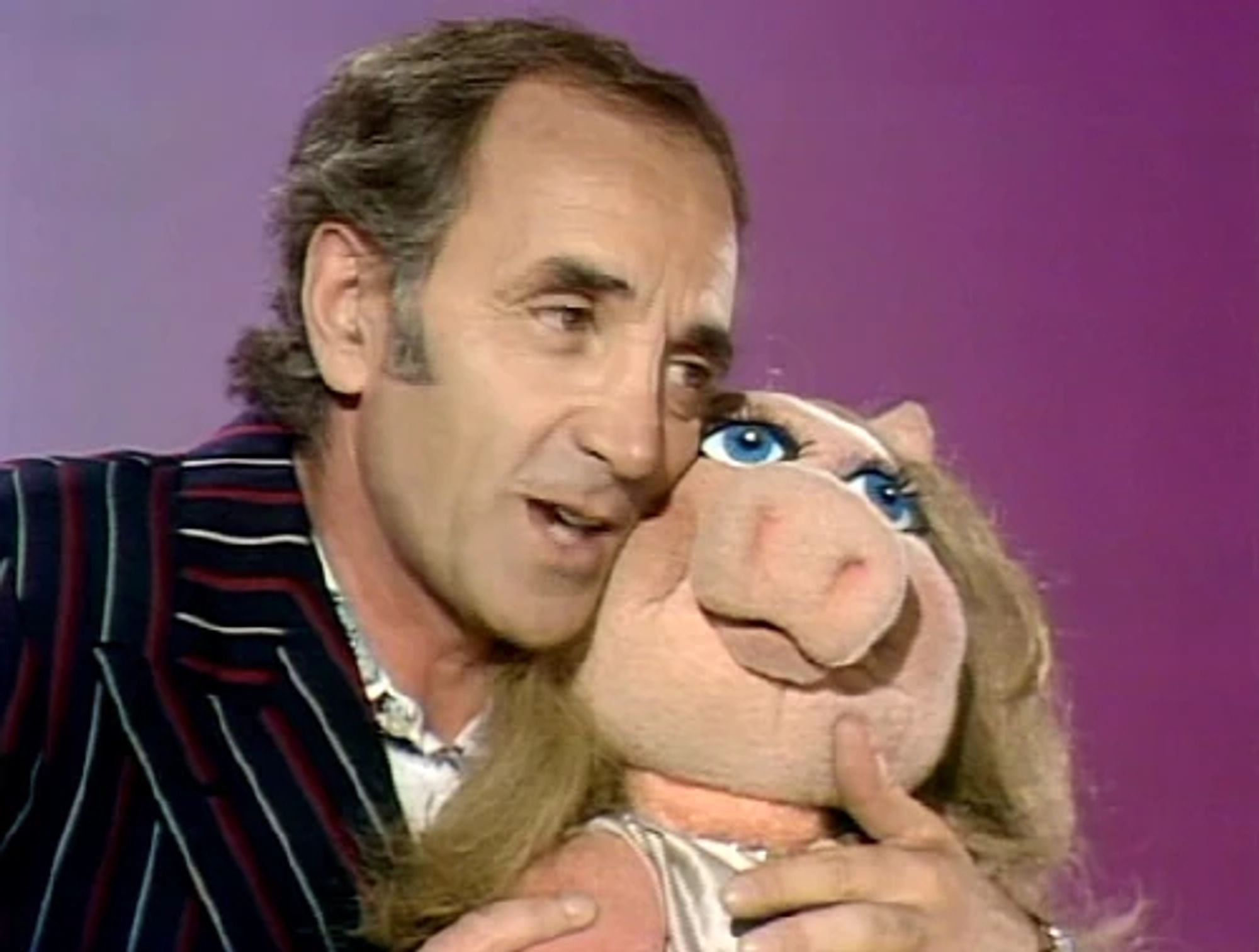 Charles Aznavour embracing Miss Piggy