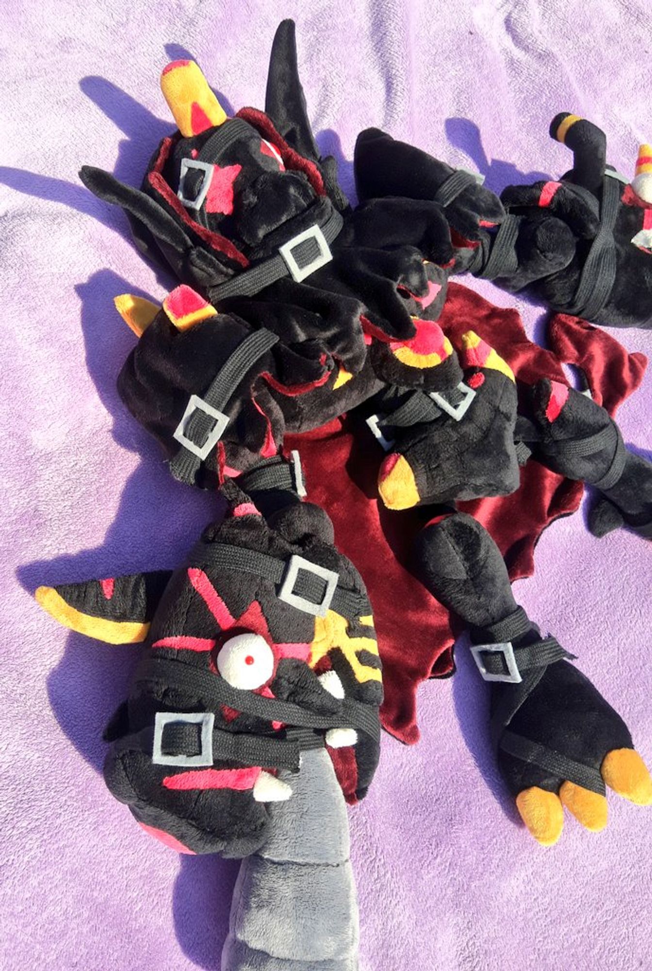 A plushie of the digimon Omegamon Zwart Defeat.