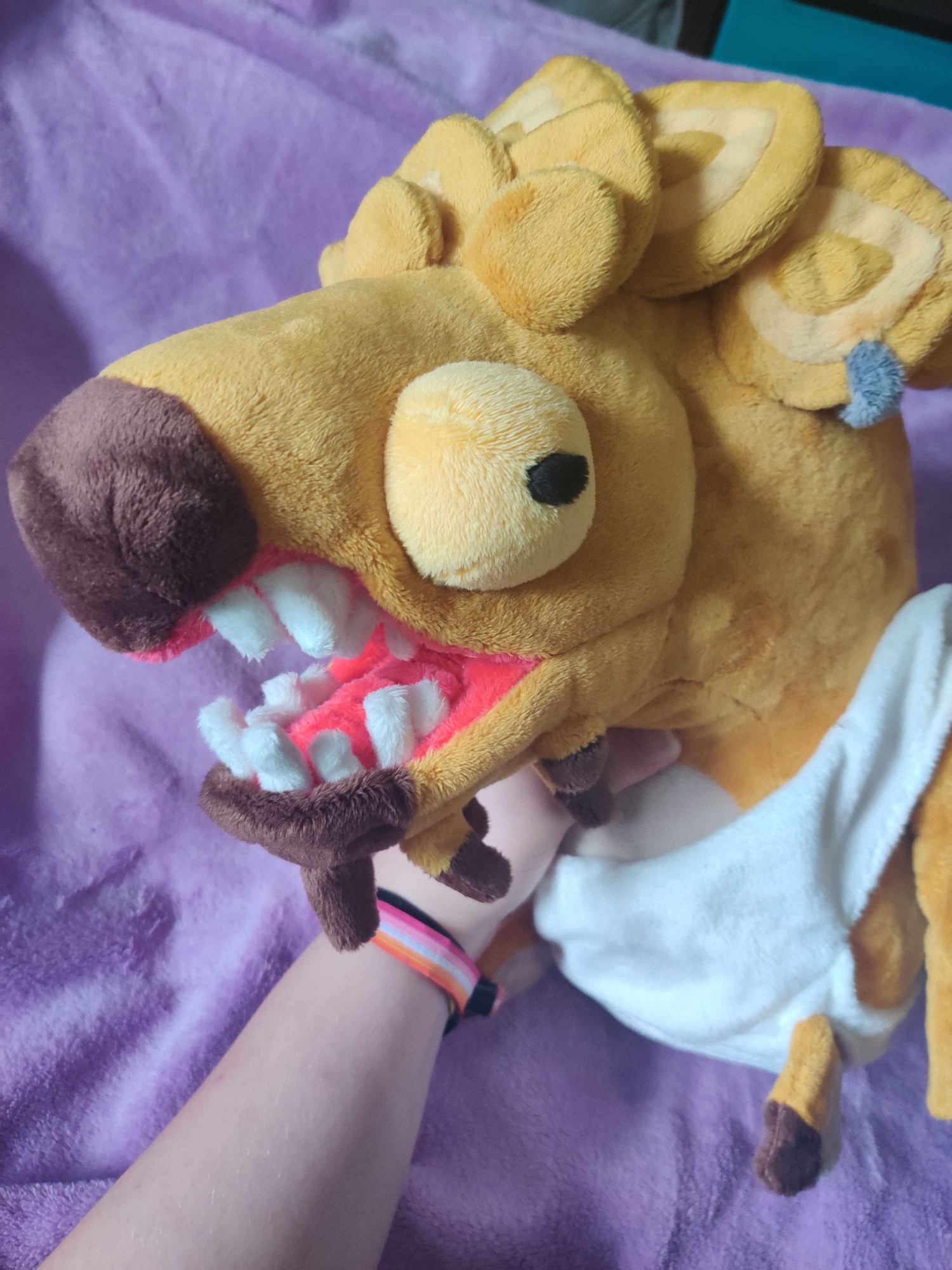 A golden fish plush shown from the front