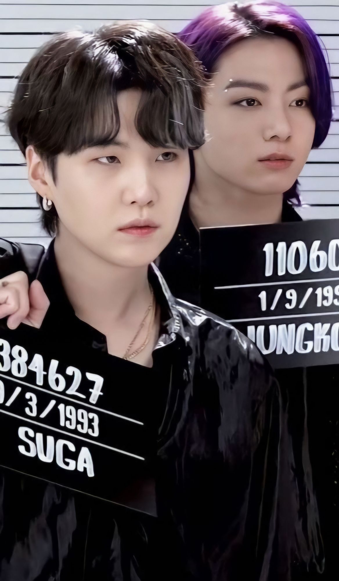 Purple haired Jungkook and brown haired Suga on the set of the Butter music video holding up their mug shot signs. I can't really describe how their eyes shapes are different but trust me, they are both amazing.