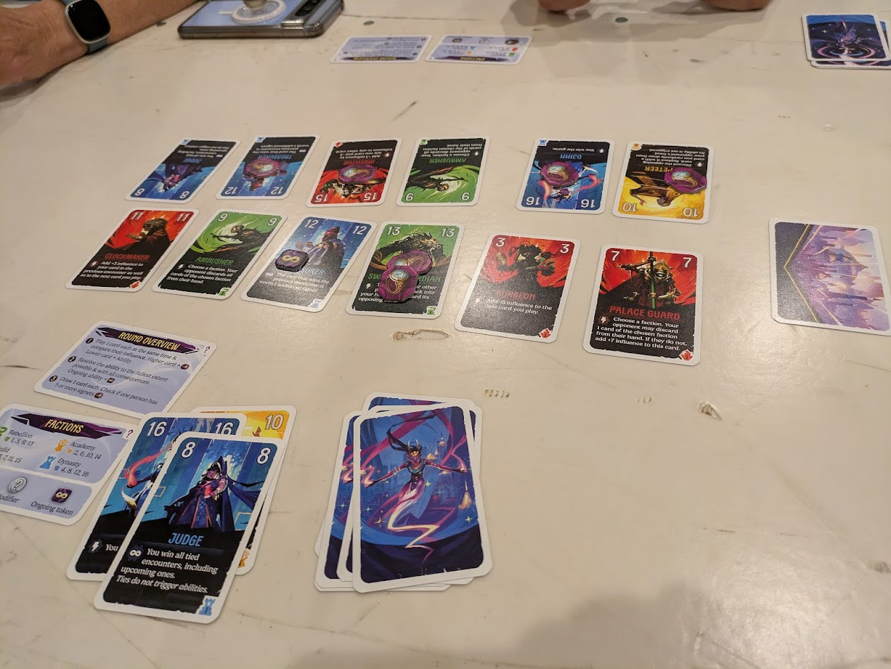 Cards laid out in 2 rows facing off against each other.