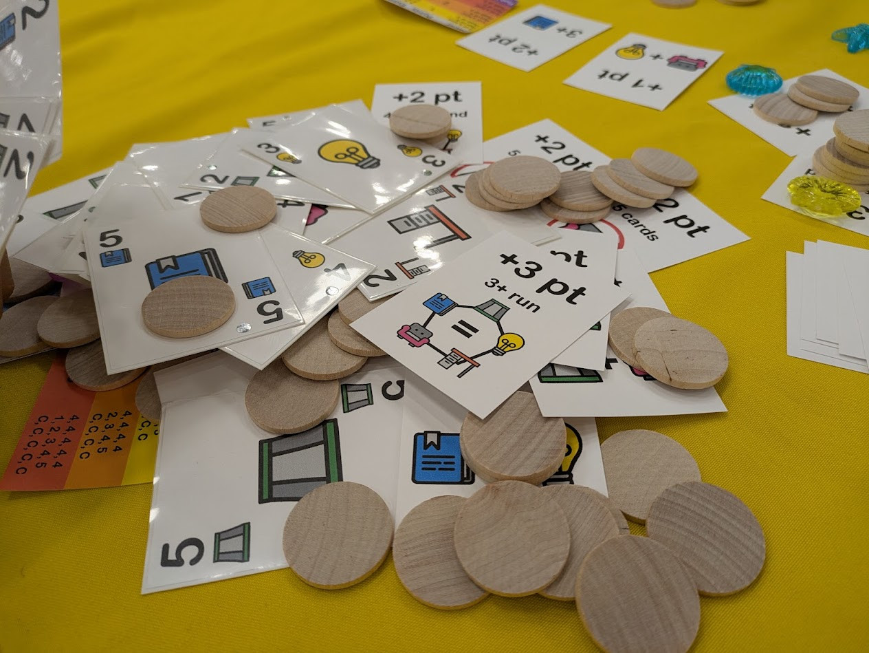 Messy pile of cards and wooden discs