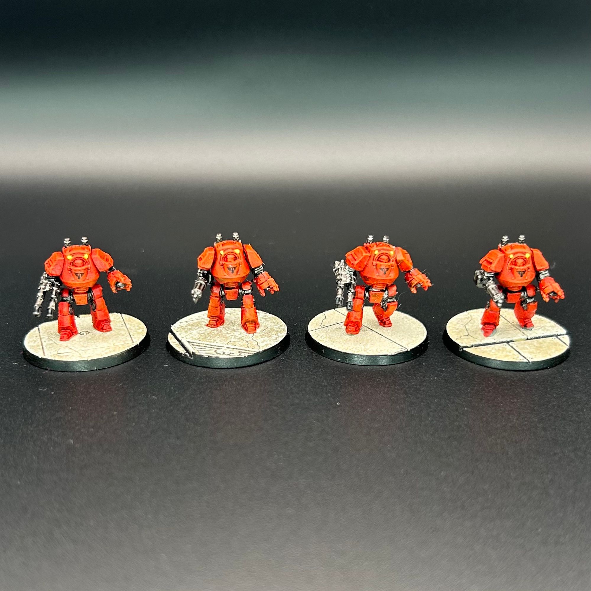 Four Blood Angels Contemptor dreadnoughts for the epic-scale miniatures game Legions Imperialis.