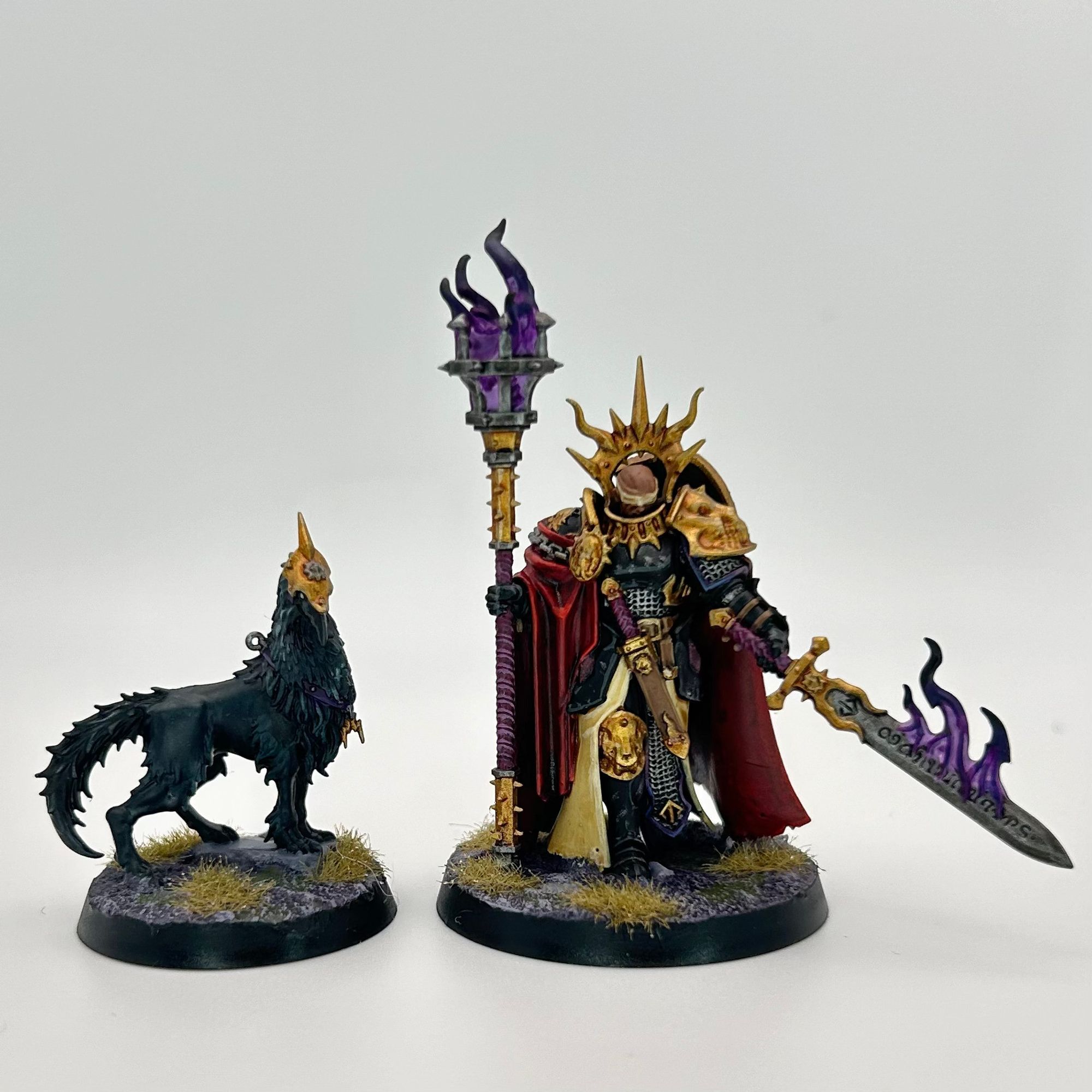 A Lord-Veritant and Gryph-Crow from the Anvils of the Heldenhammer stormhost of the Stormcast Eternals. She has a flaming sword and brazier that contain purple flames. The gryph-crow has a helmet.