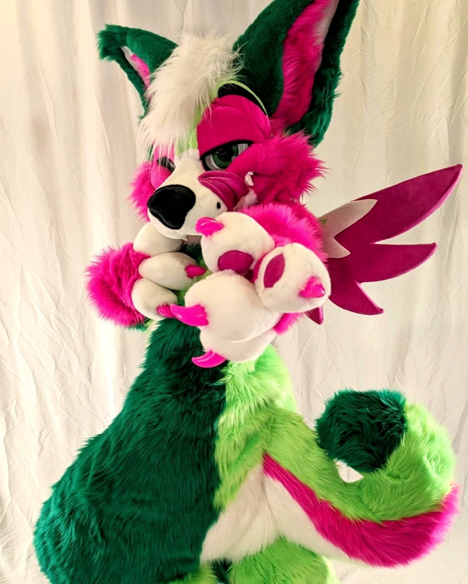 Melon in fullsuit pointing towards thr camera.