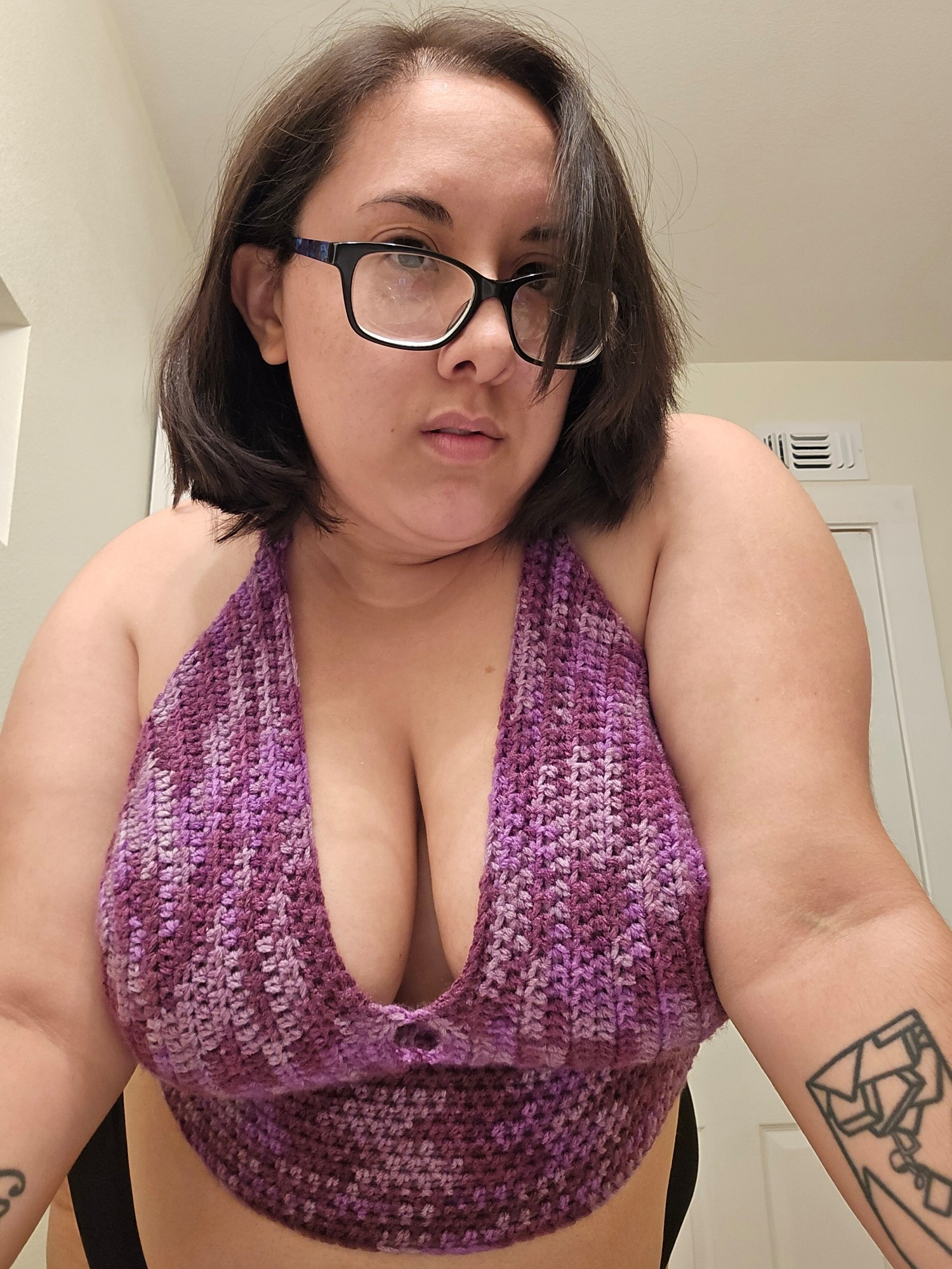 Me in a crocheted purple bralette top.