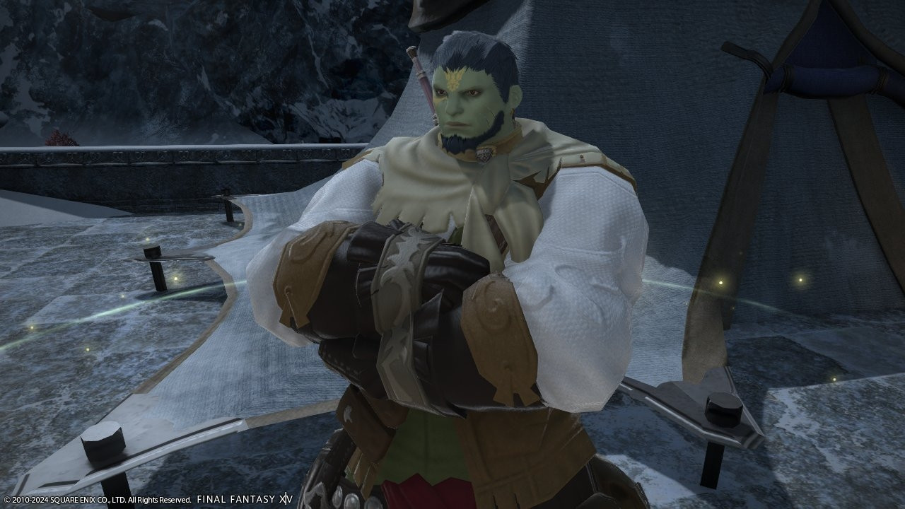 A screenshot from Final Fantasy XIV depicting my player character Han'urel, a green-skinned roegadyn man with short blue hair and a beard. He has golden tattoos on his forehead and under his right eye, and scars on his left jaw. He is dressed in fishing attire with his arms crossed.