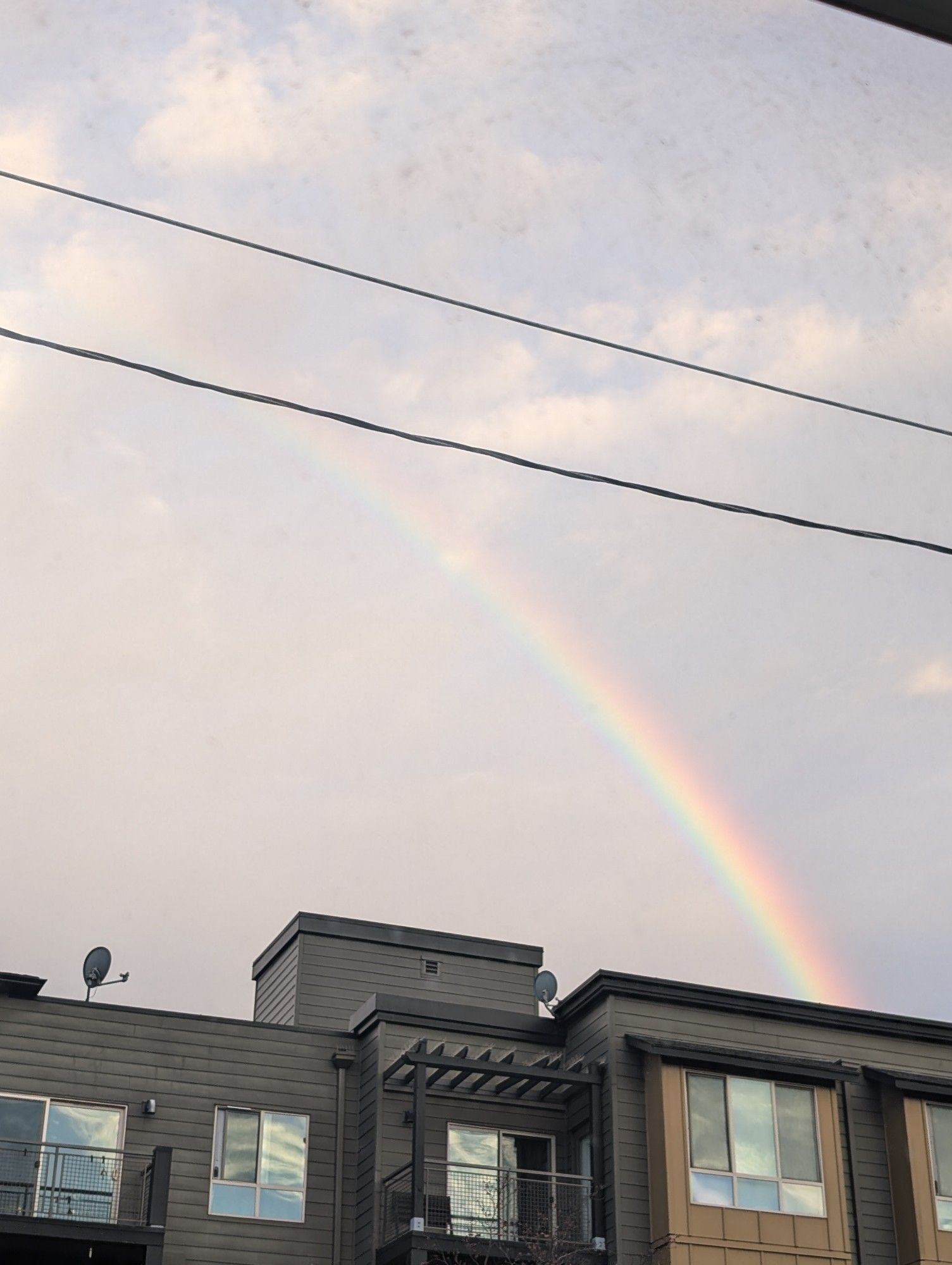 Rainbow over apartment building.