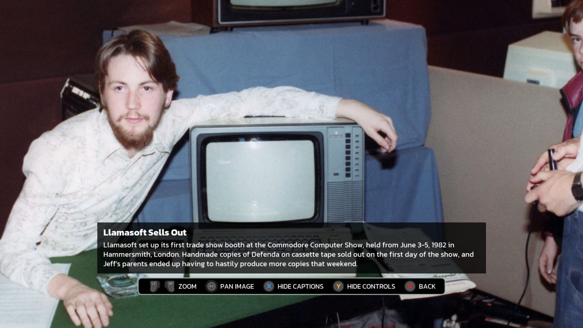 A young Jeff Minter at a computer show, with a caption explaining the context of the photo