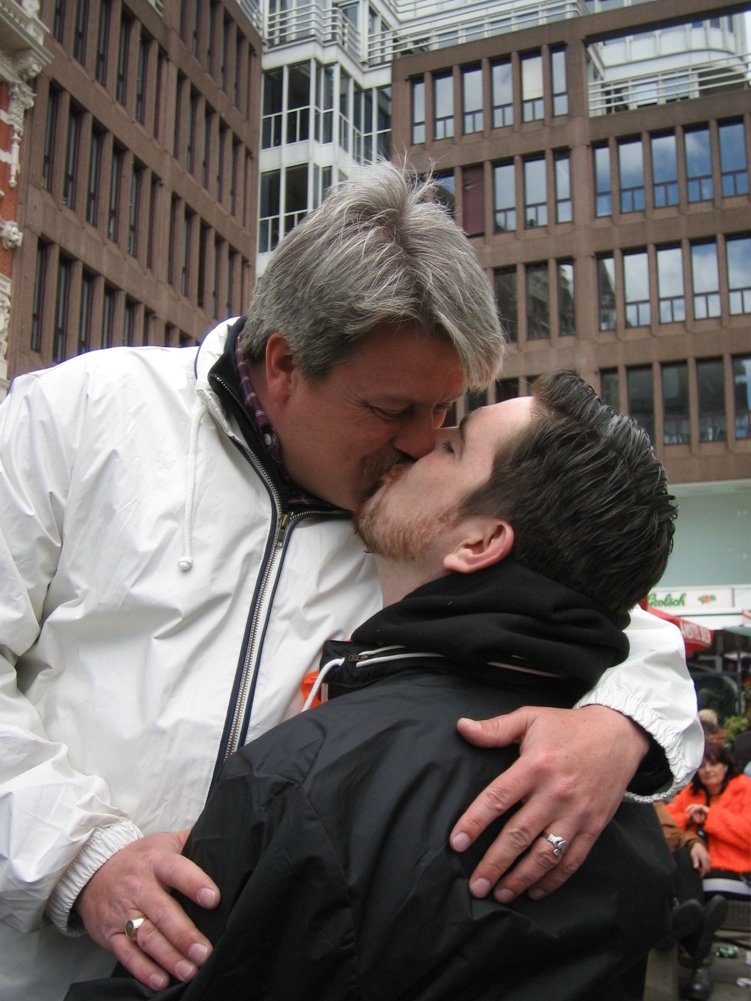 Two men kissing at the Homomonument in Amsterdam. Queen’s Day 2006