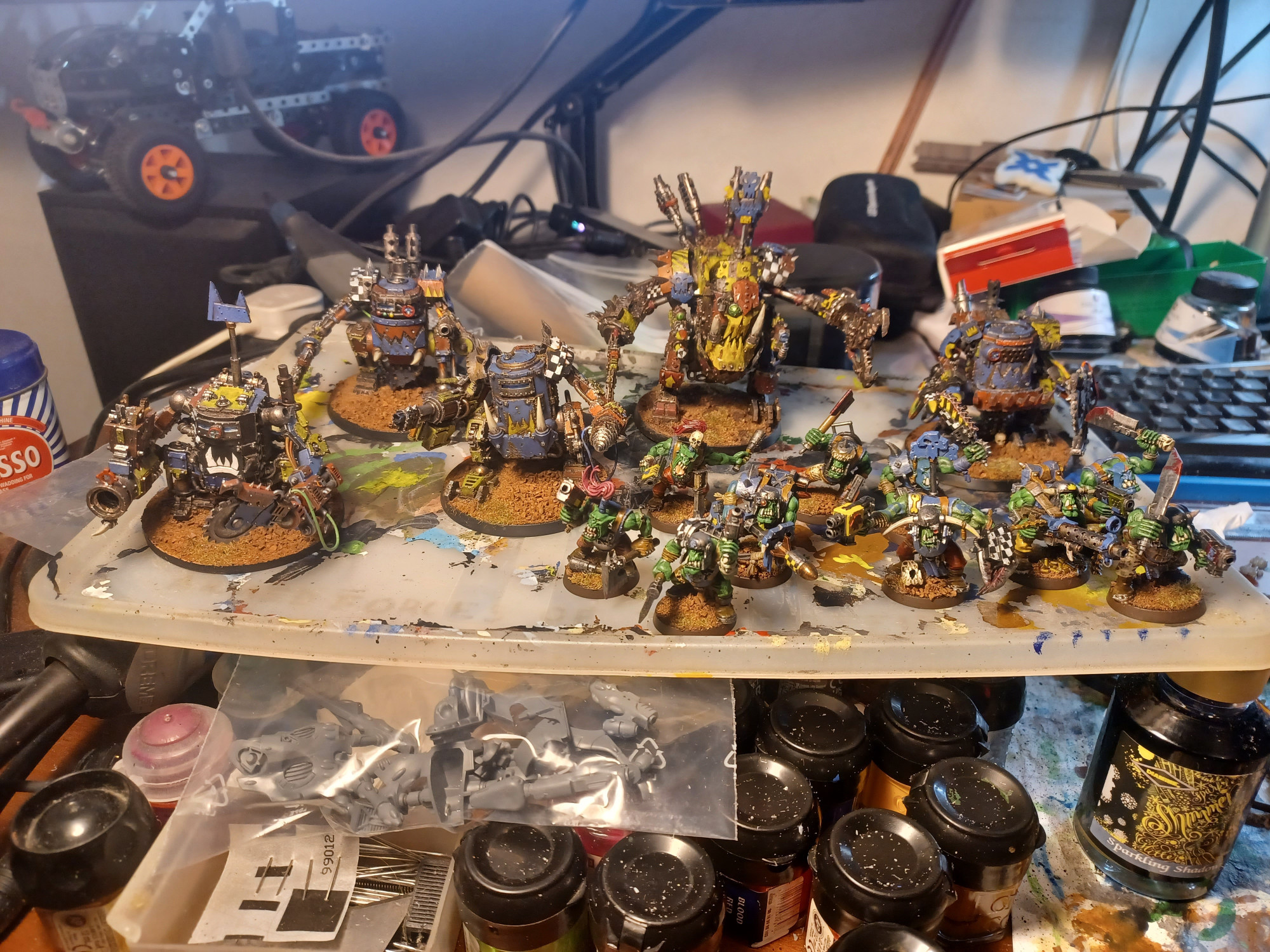 A small force of Warhammer 40,000 Orks on a plastic painting tray; there is a squad of eleven Ork Boyz at the front right of the picture including a Nob with a Power Klaw, a Big Shoota, a Rokkit Launcha, two Boyz with demolition charges and stikkbomz. There is a Deff Dread second from the right in the back row equipped with two Deff Dred Close Combat Weapons (a power klaw and a chain klaw), a Rokkit Launcha and a Kustom Mega-Blaster. There are four Killa Kans, three on the left of the image and one at the right-hand end of the back row; these have a mix of close combat and ranged weapons from the Ork arsenal.

The force is clearly made up of Orks of the Deathskulls clan, with blue livery being fairly prominent, though a lot of their gear and a lot of parts on the various walkers are clearly stolen from other Ork clans, being painted in the colours of the Evil Sunz, Bad Moons, and Goff clans.

The Deathskulls are notorious among Ork clans as profligate thieves.