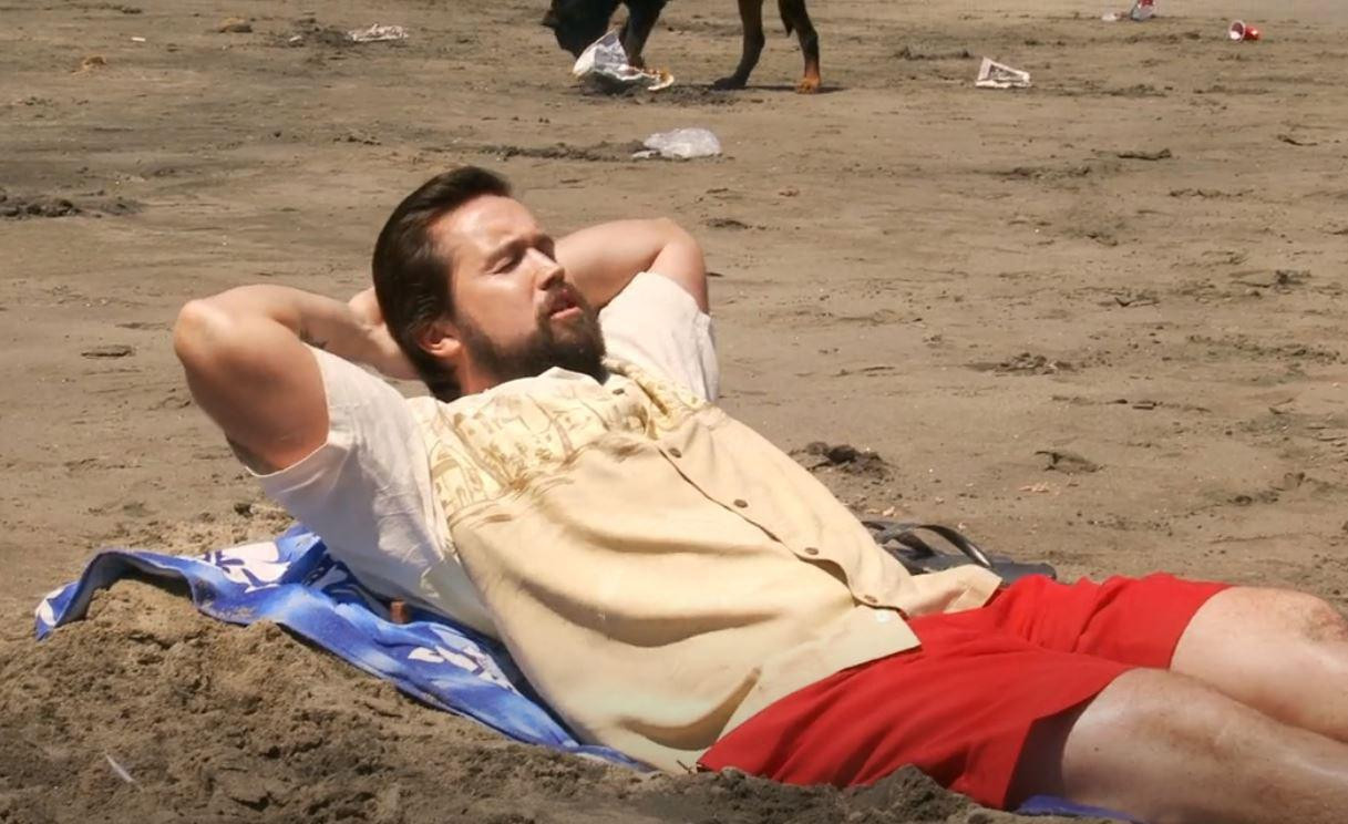 Mac from IASIP relaxing on a beach towel