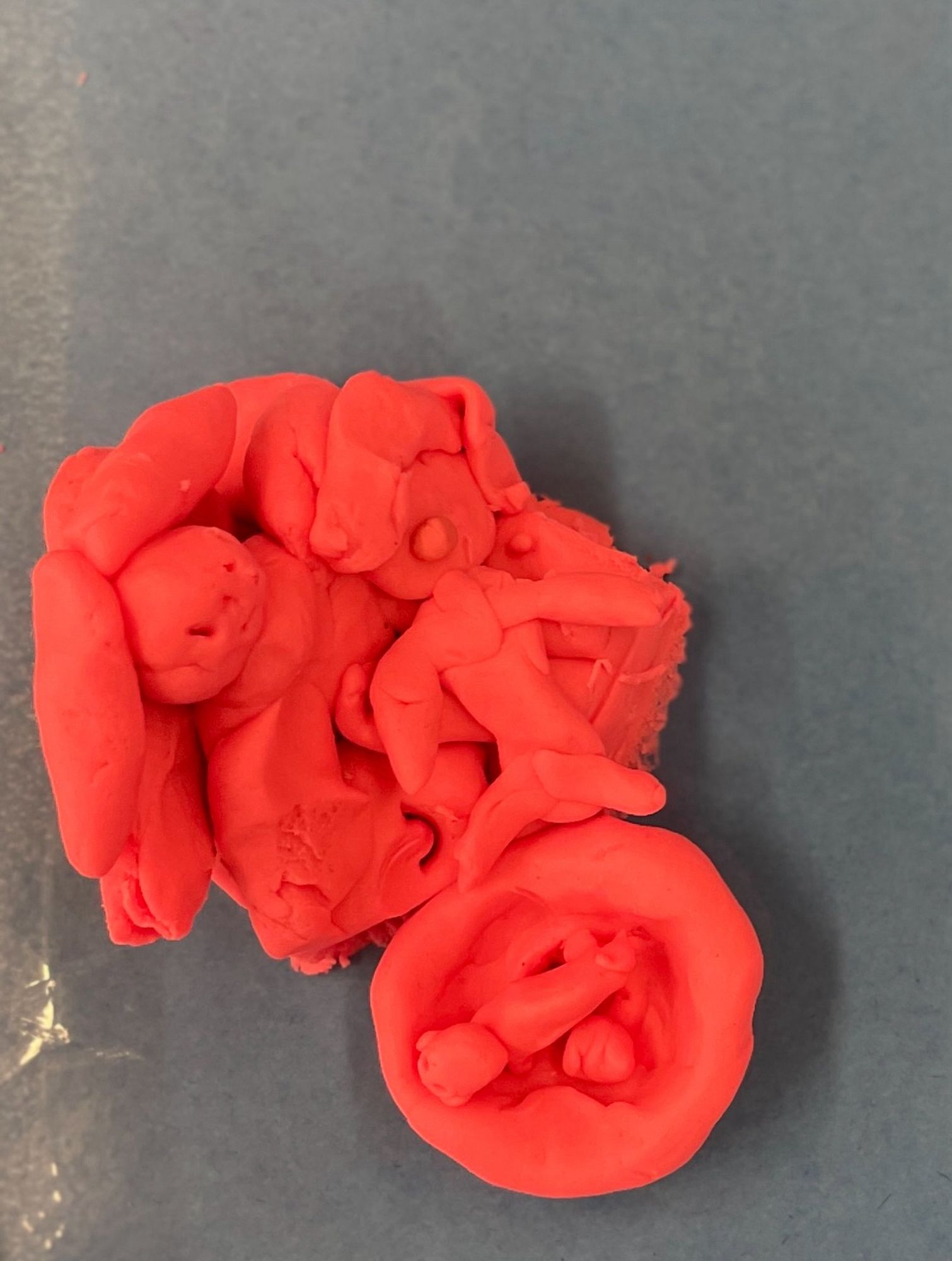 A Play-Doh scene from a story with a mother holding a child.