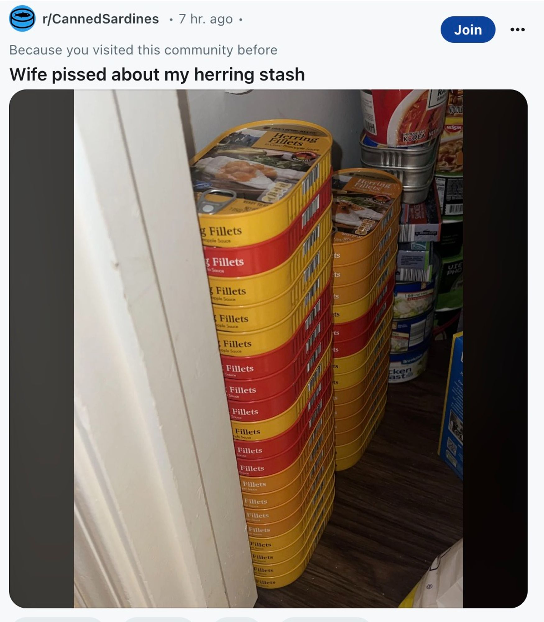 screenshot of a reddit post with the text "Wife pissed about my herring stash" and a photo of a large stack of tinned herring