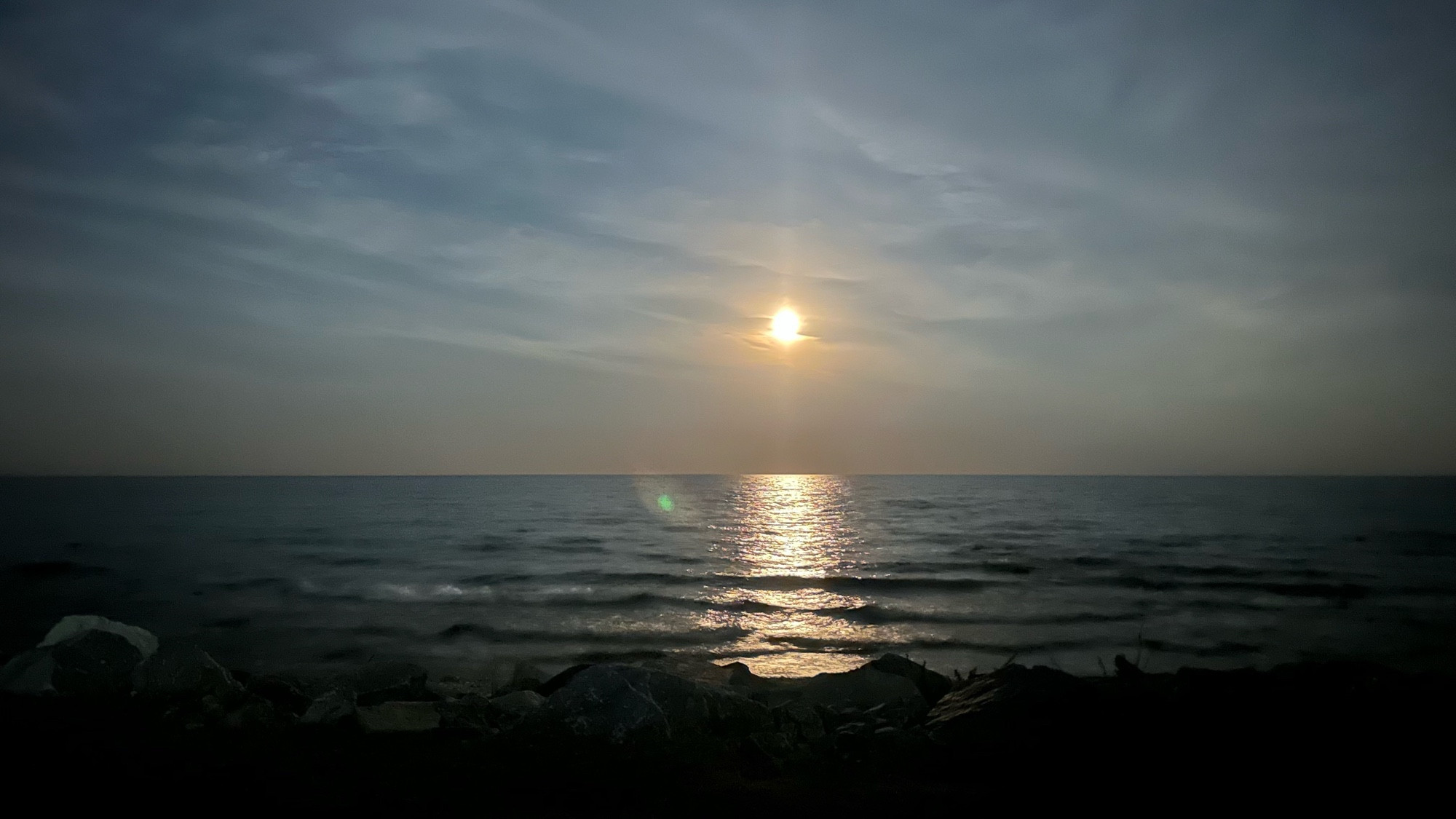 Super moon rising over Lake Michigan shoreline.