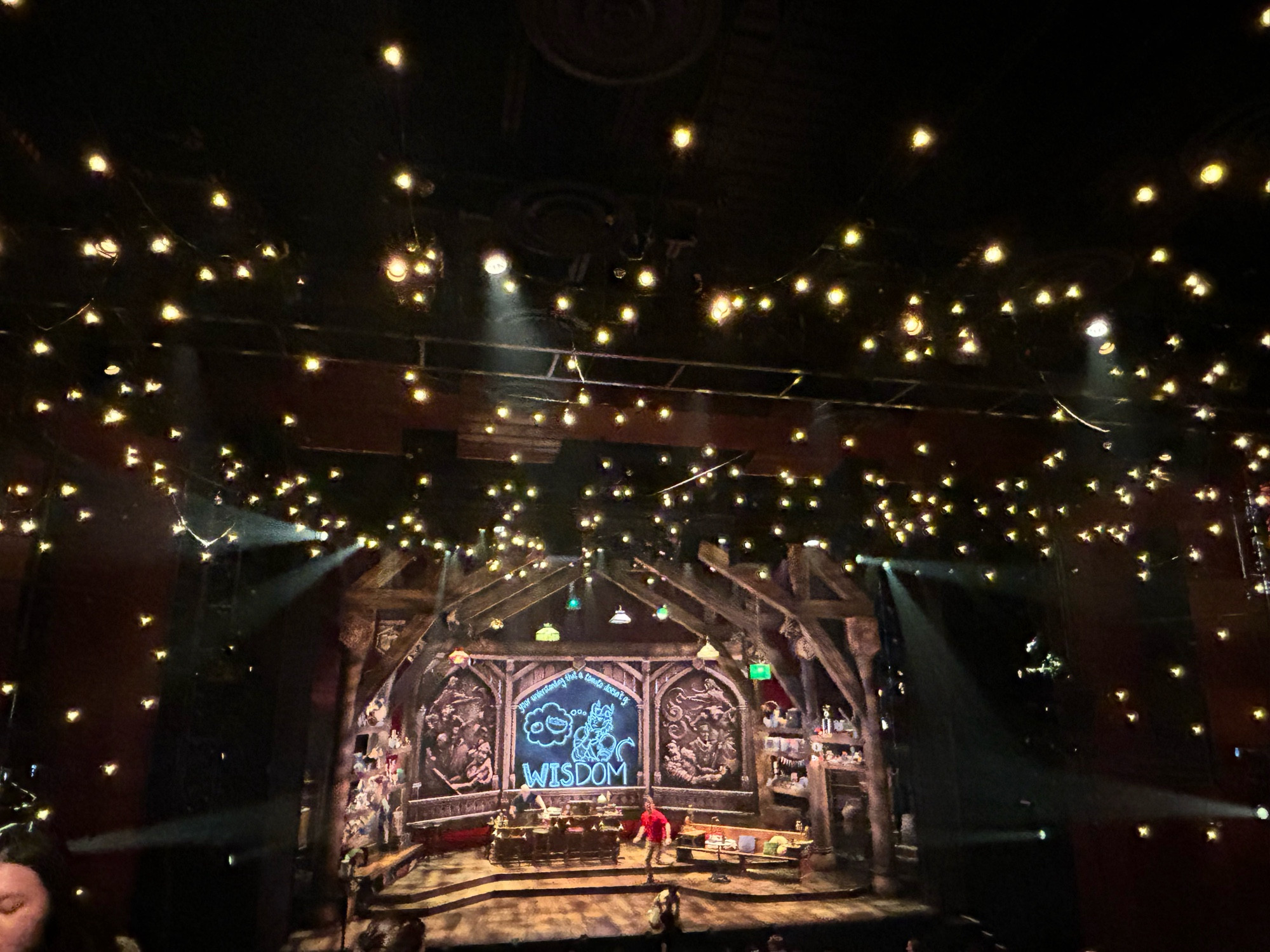 From a distance, the set of Twenty Sided Tavern with sparkling lights overhead