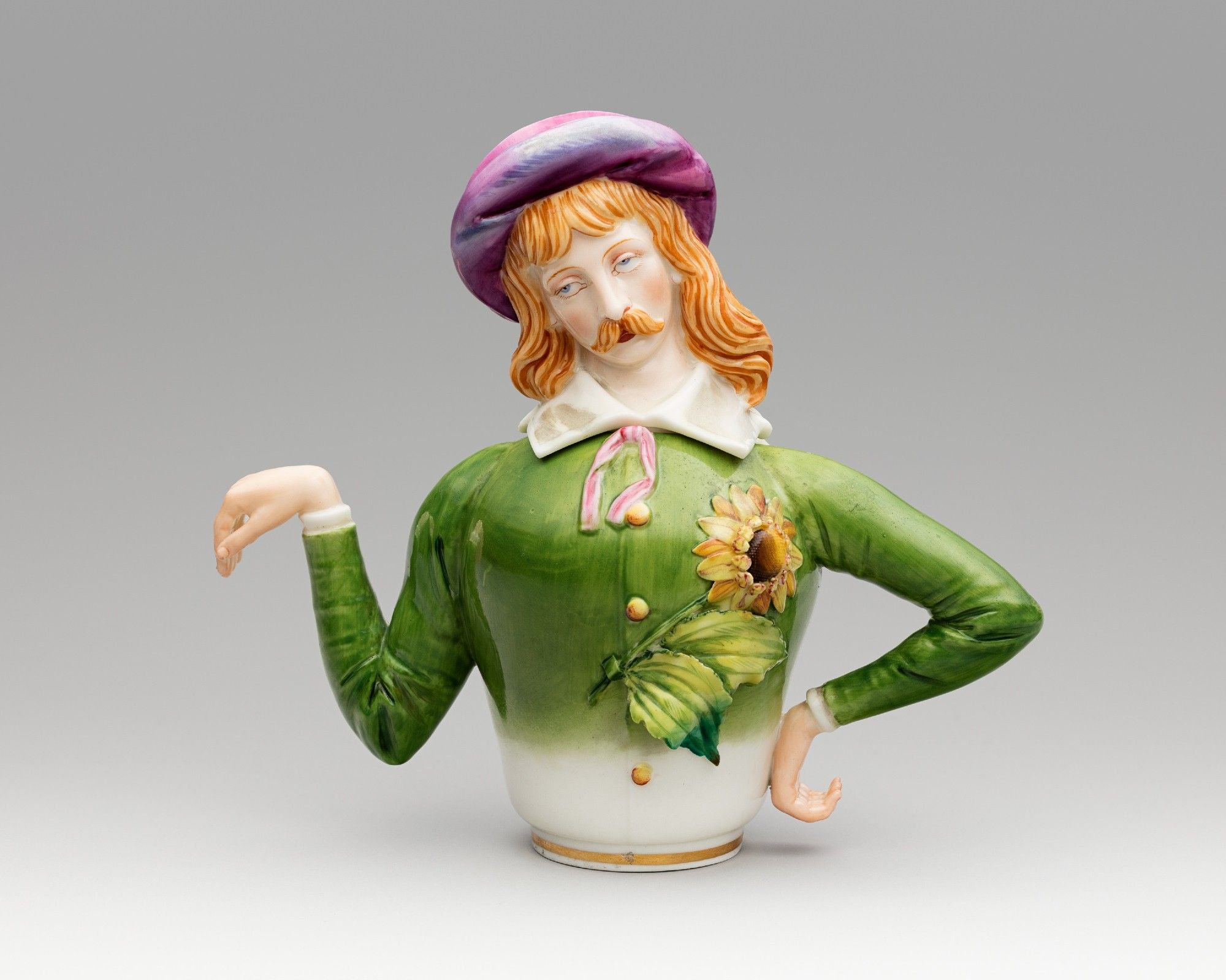 A teapot in the shape of a person. One arm serves as the spout, the other arm is the handle.