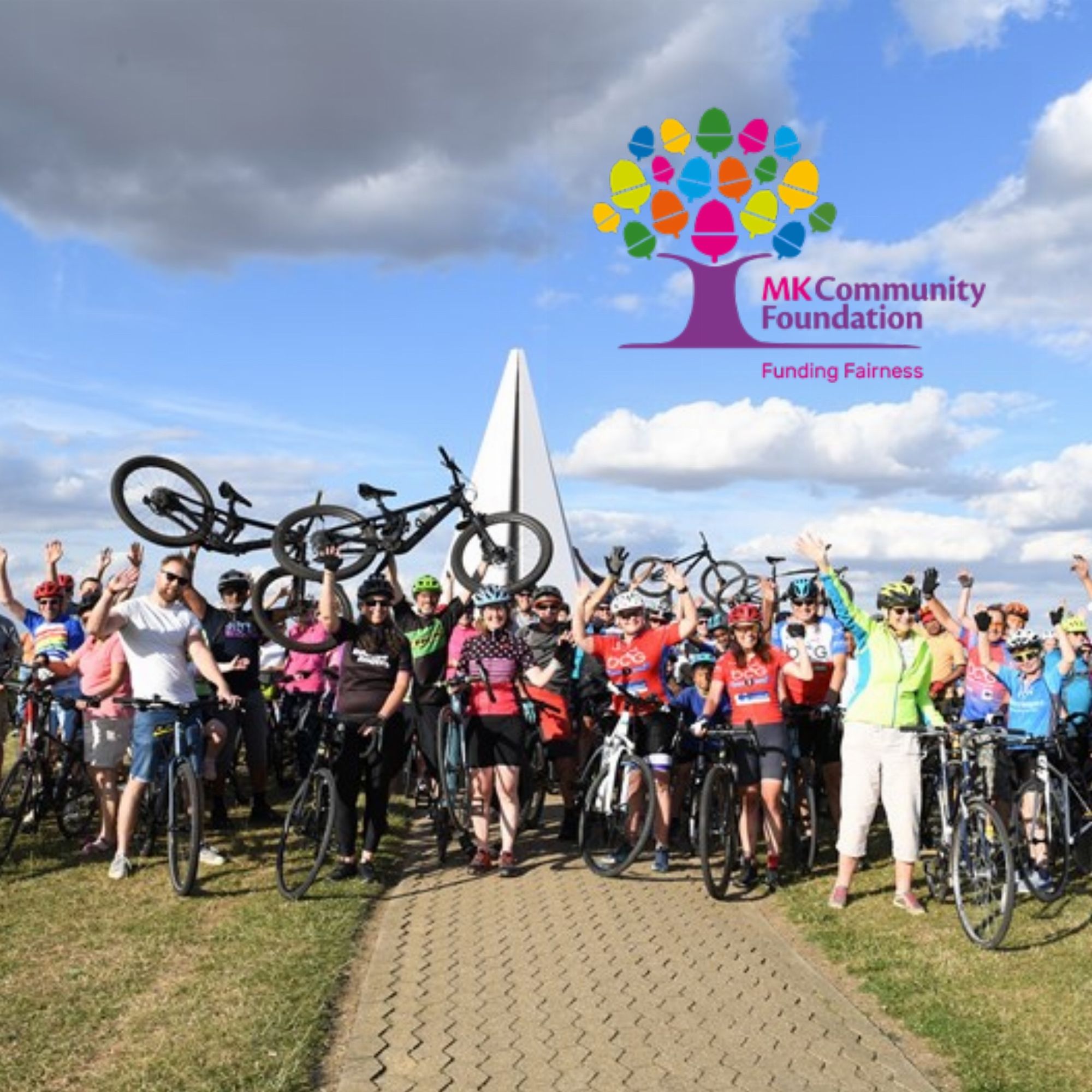 A collection of community cyclists celebrating their charity contribution. MK Community Foundation charity logo in the top right hand corner.