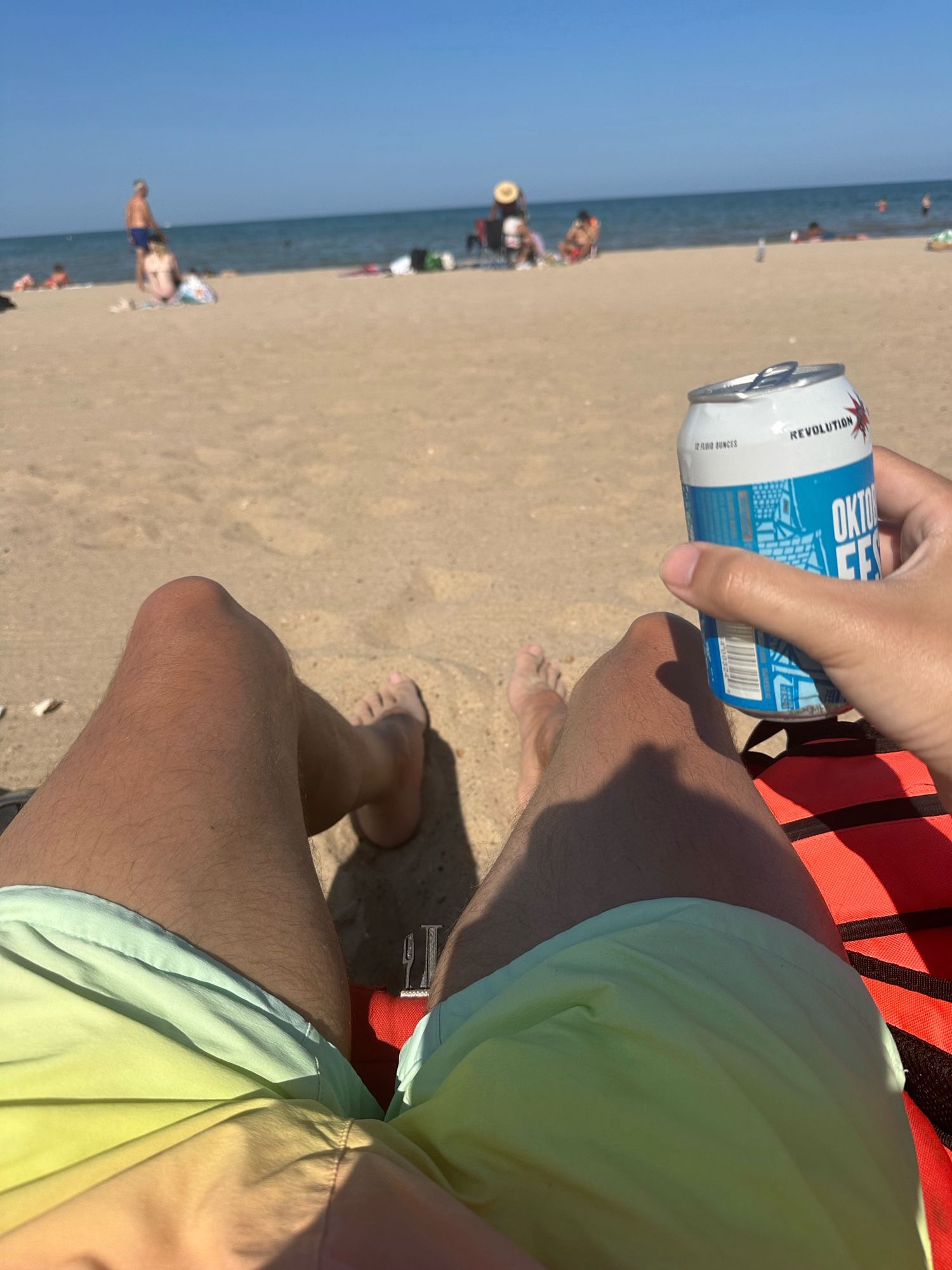 POV: You’re sitting in a beach chair at Hollywood Beach in Chicago, looking at your feet in the sand and the beer in your hand