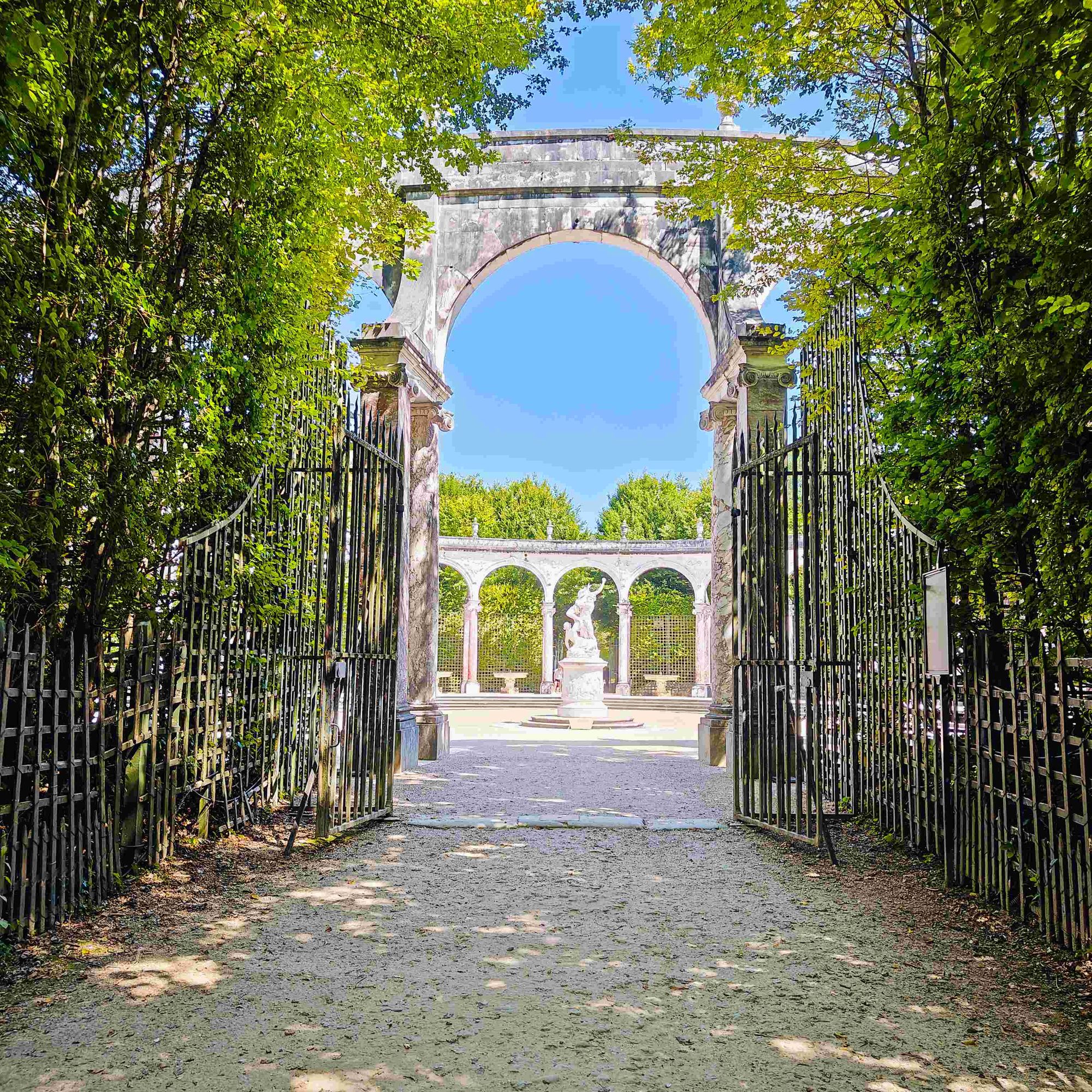 view of a gate entrance into a garden at the Gardens of Versailles