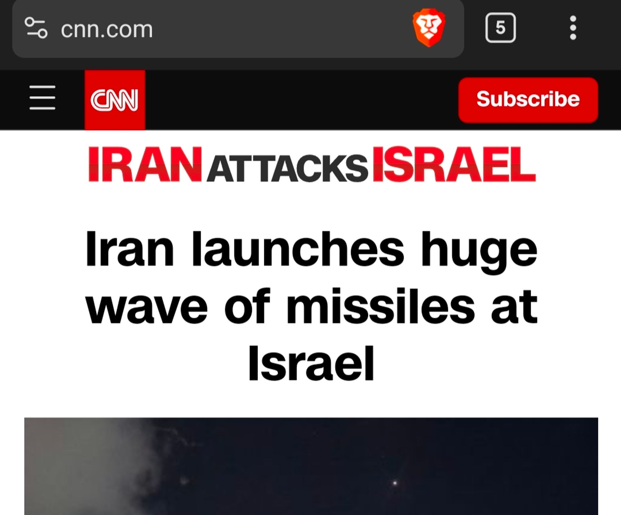 The CNN homepage, reading at the top: "IRAN attacks ISRAEL" IRAN and ISRAEL are both in red. Below that is the actual headline about Iran launching missiles at Israel