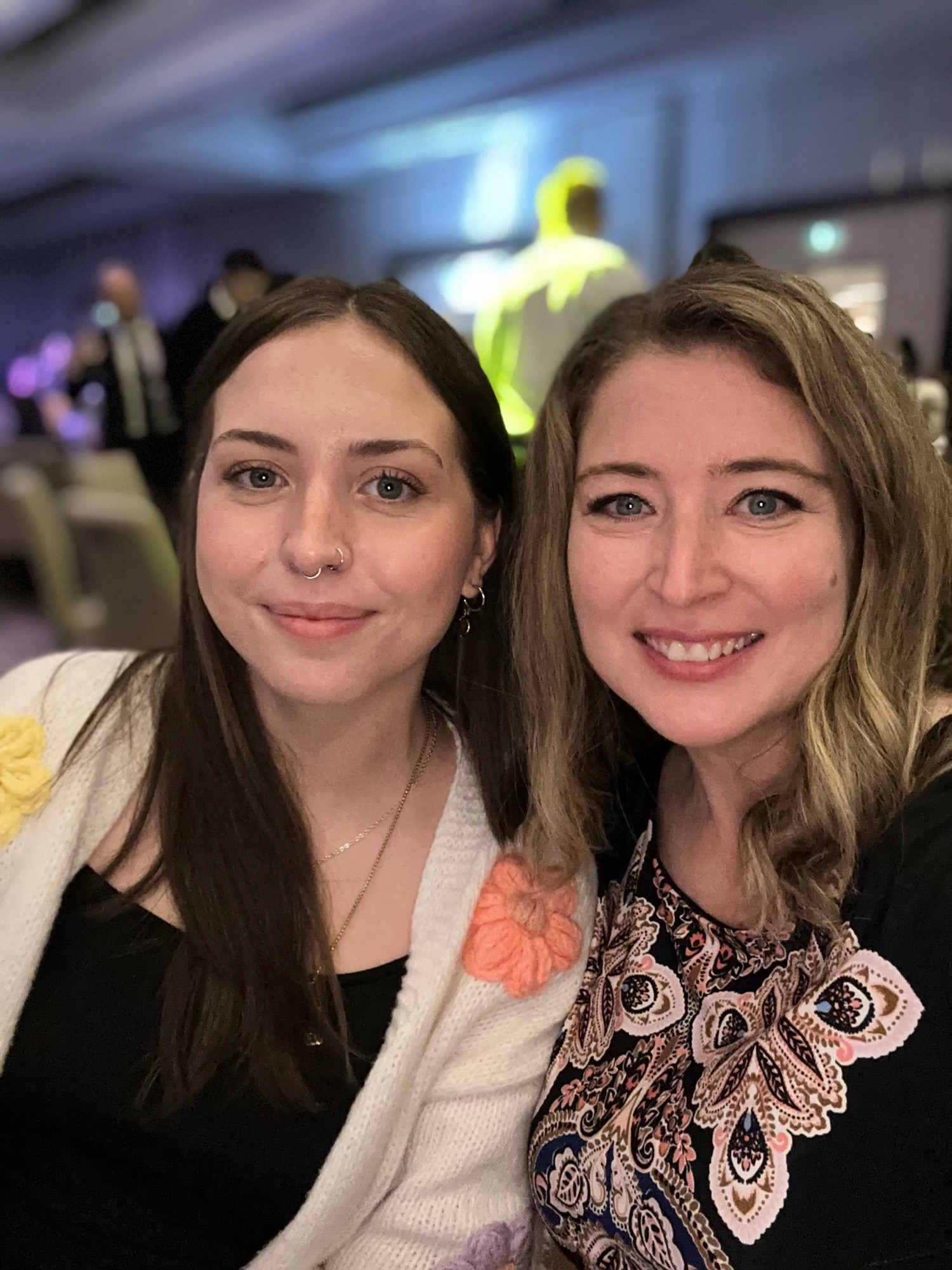 A selfie portrait of two smiling women, my niece on the left and me on the right