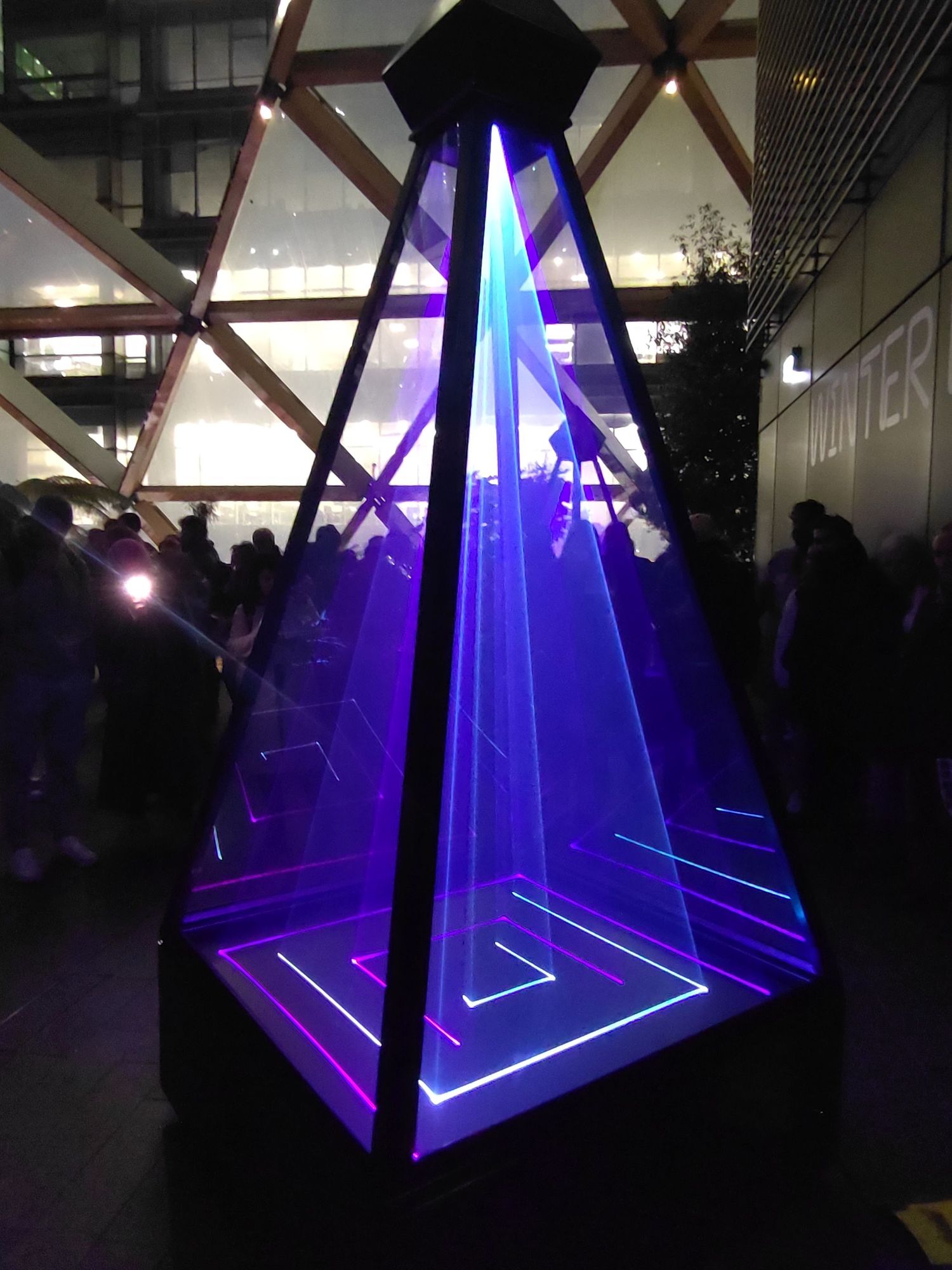 Vessels is a sculpture where science, technology and culture collide. A modern take on monuments. Three monolithic pyramid structures. Inside the tall pyramid, coloured lighting created by the lasers, dances in synchronisation with melodic music. Inspired by the Pyramids of Egypt and monolithic structures.