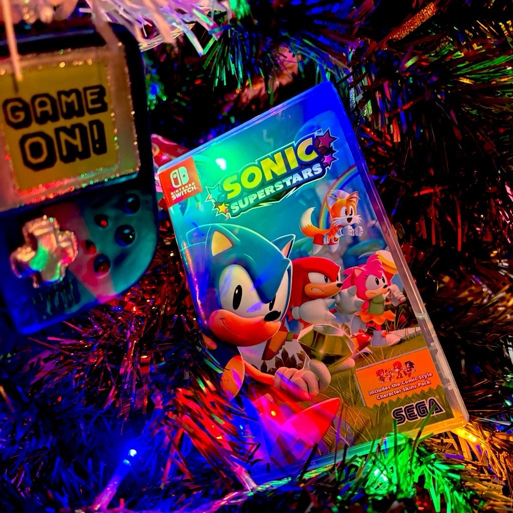 A copy of Sonic Superstars for Nintendo Switch in my Christmas tree, with multicolour lights