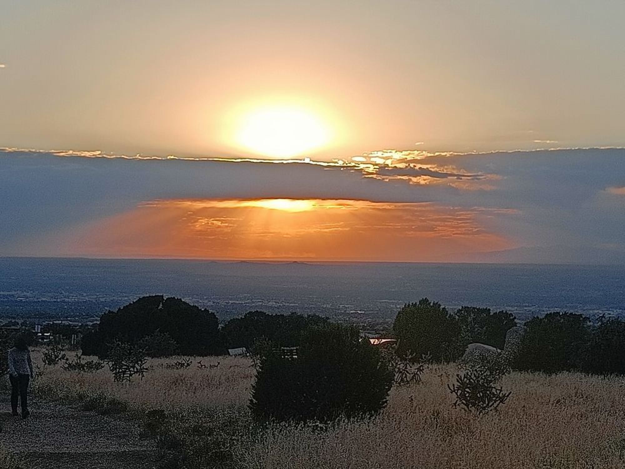 sun setting behind clouds