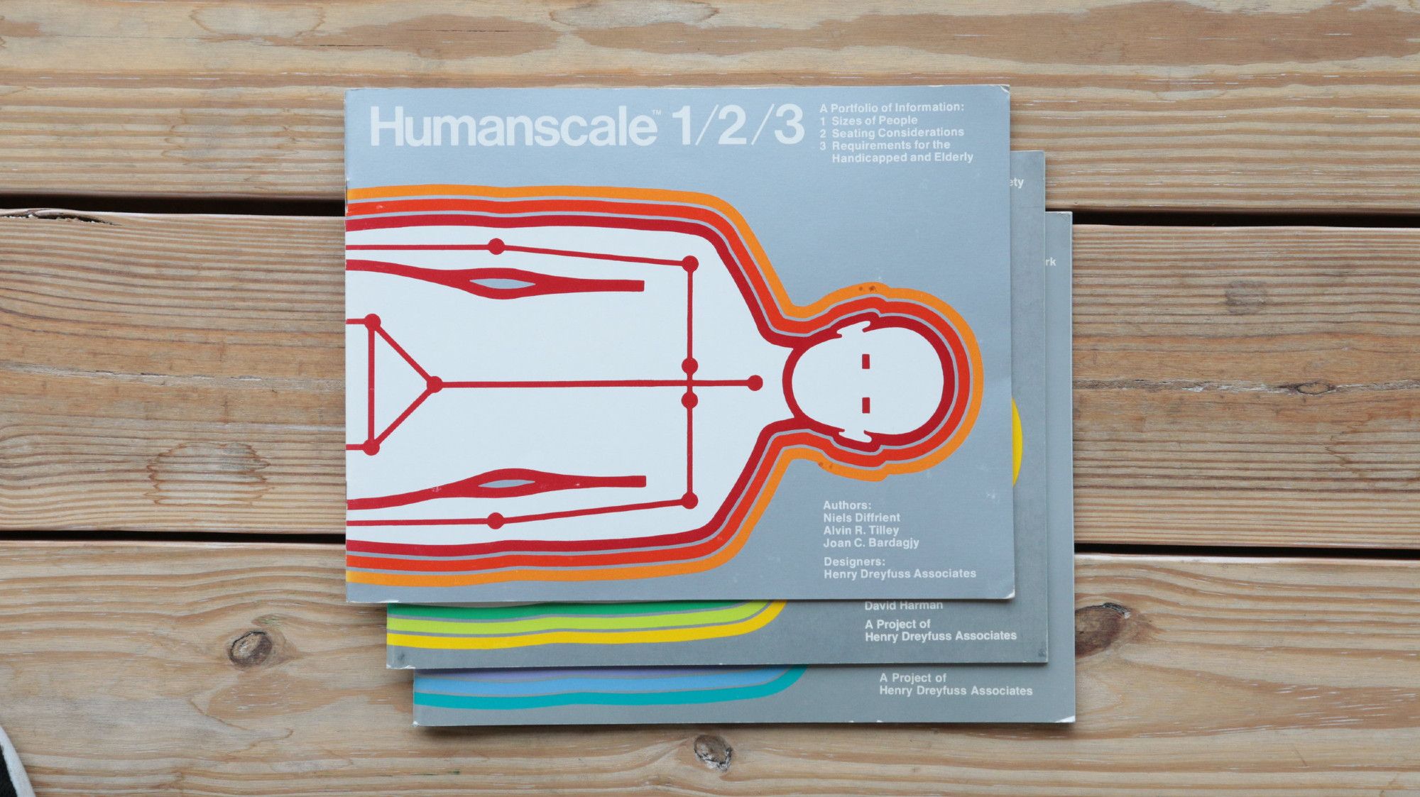 Stacked covers of the Humanscale series. Each cover features a stylized vector outline of a person wrapped in colored stripes.