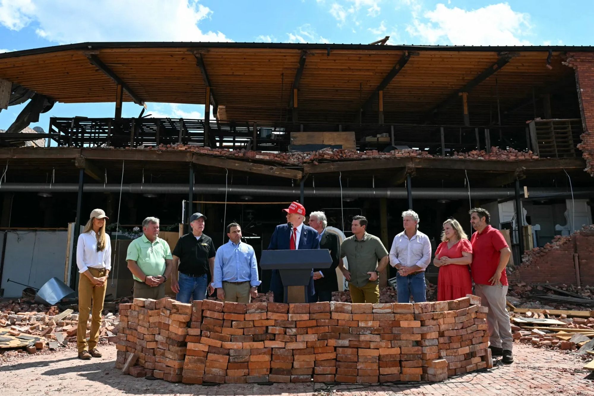 Mango Mussolini rearranging destroyed buildings into his own little bunker bitch fencing in Valdosta Georgia with dog murdering Gov Kristi Noem